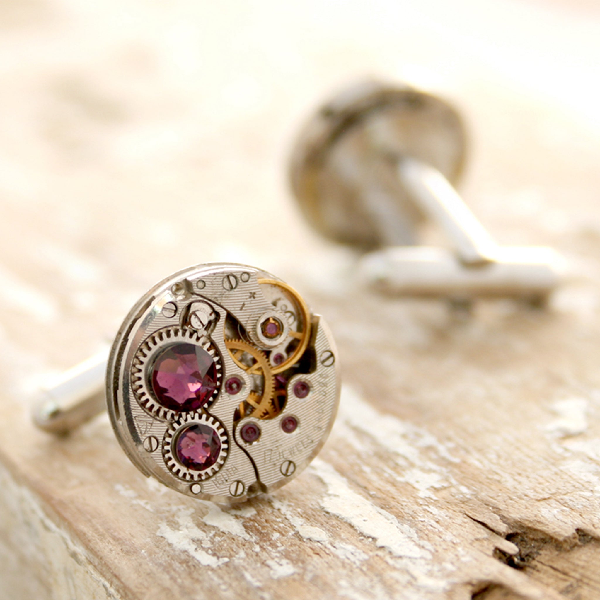 birthstone cufflinks in steampunk style featuring antique watch movements and Amethyst crystals