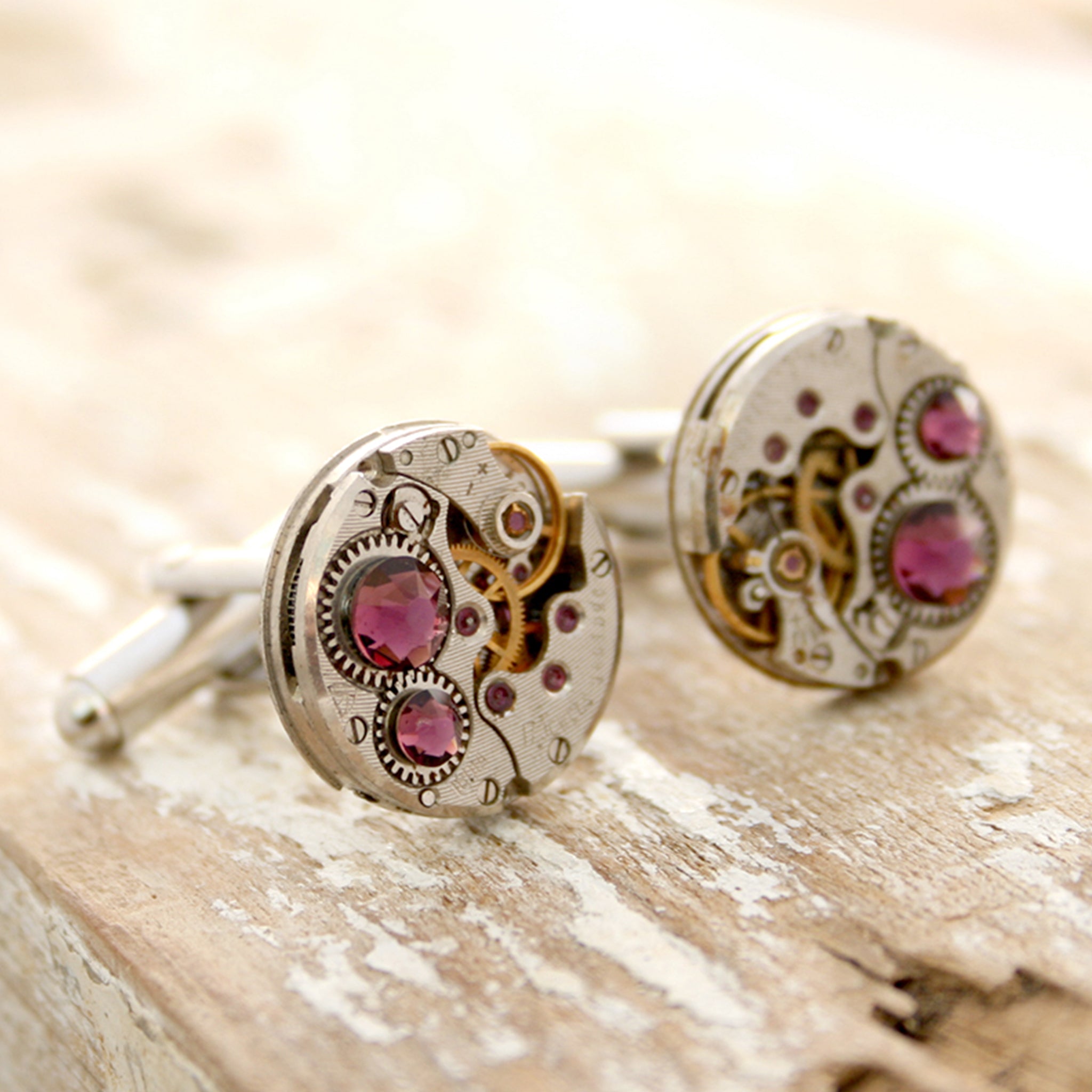 birthstone cufflinks in steampunk style featuring antique watch movements and Amethyst crystals