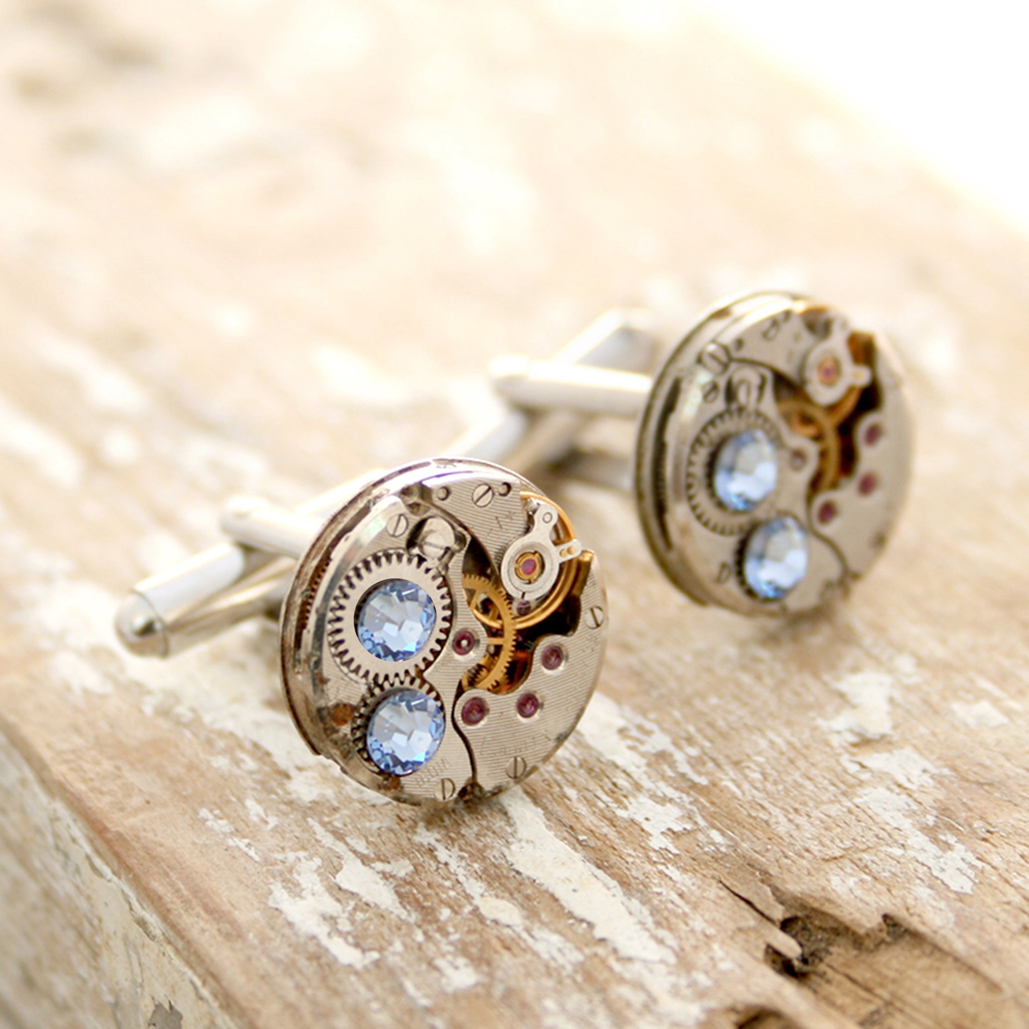 birthstone cufflinks in steampunk style featuring antique watch movements and Sapphire crystals