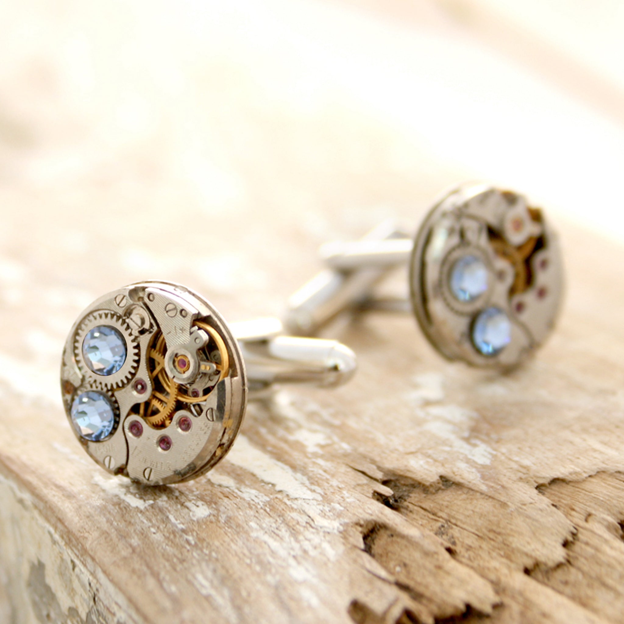 birthstone cufflinks in steampunk style featuring antique watch movements and Sapphire crystals
