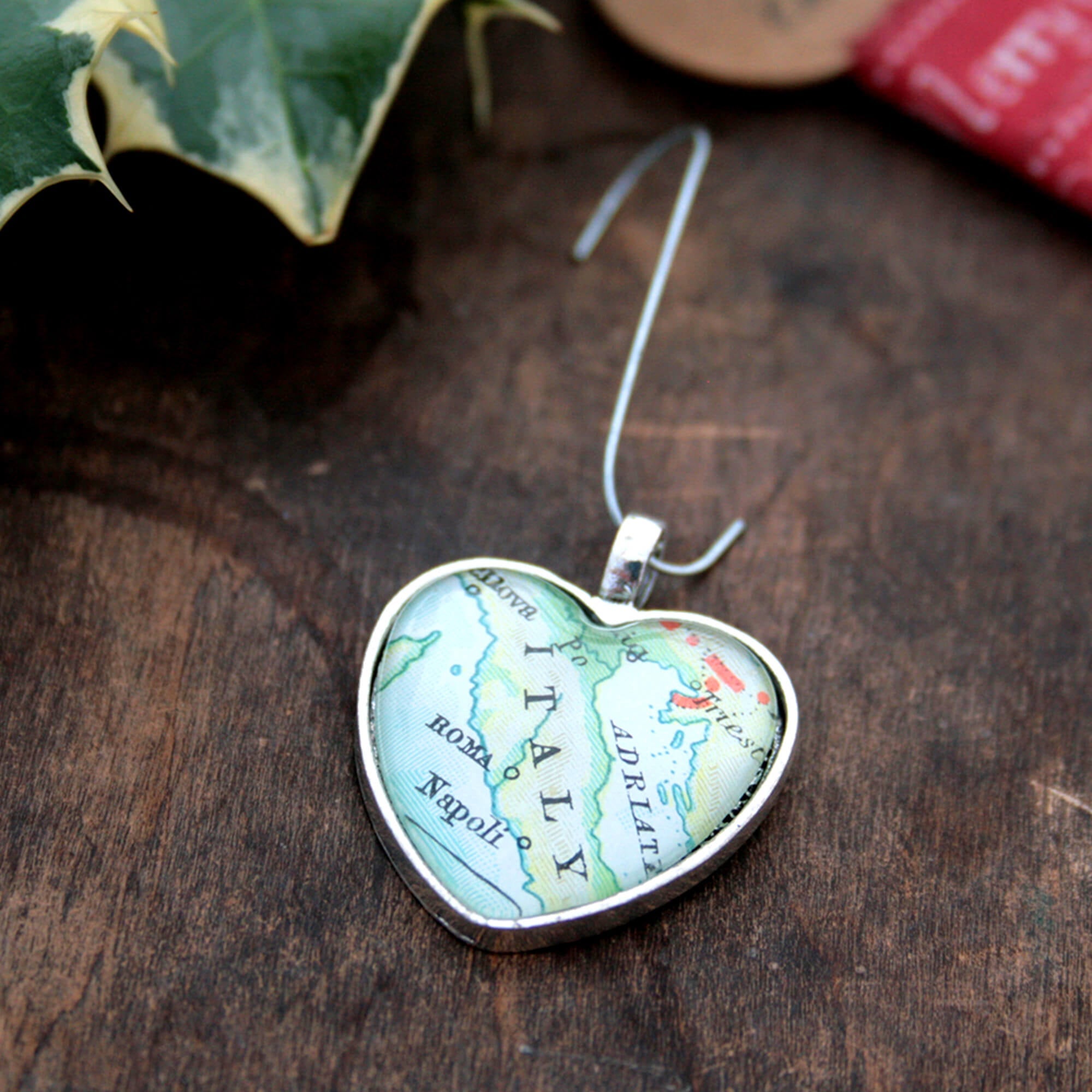 Christmas tree ornament in heart shape featuring map of the world