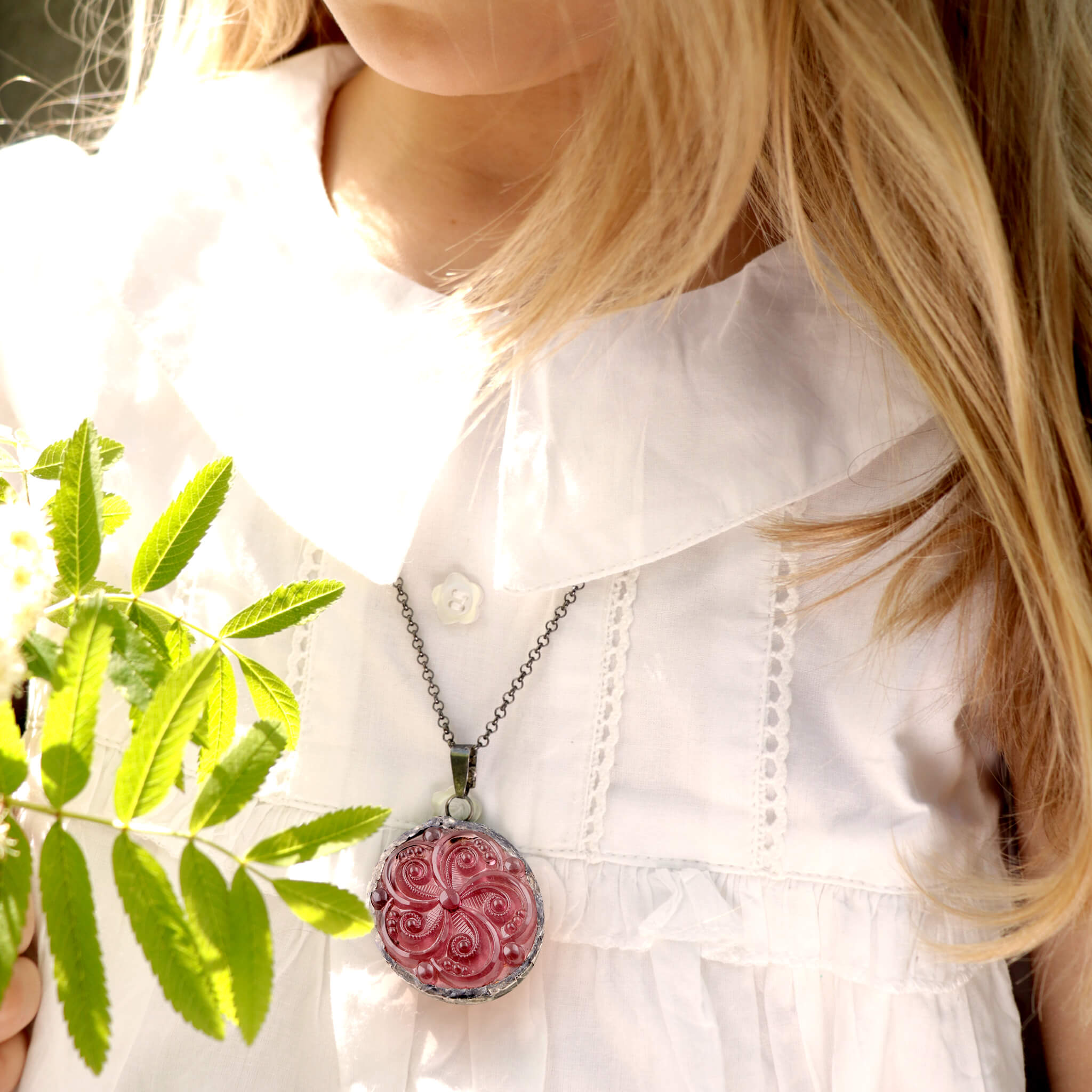 Blonde girl in white dress wearing amethyst necklace
