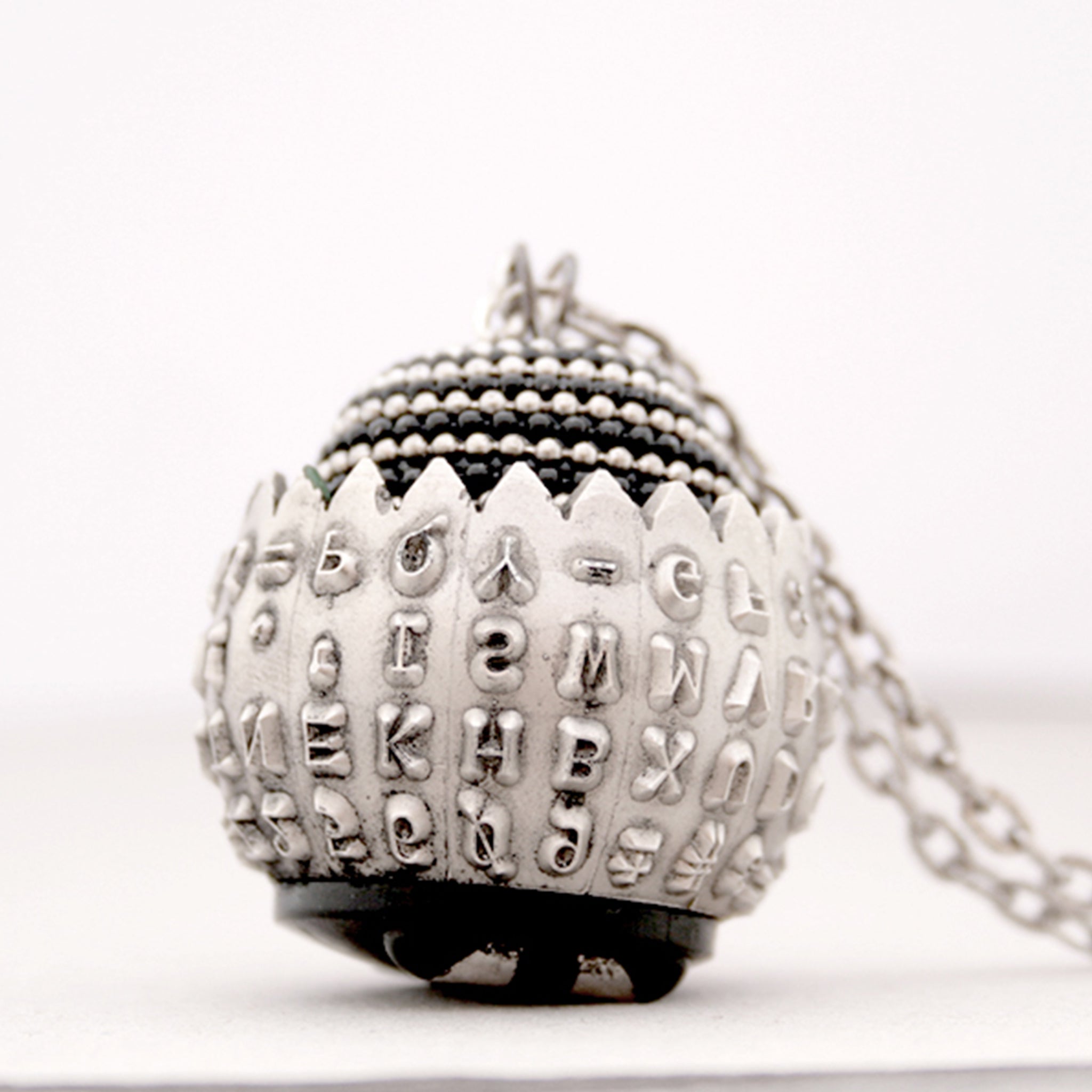 IBM Selectric typewriter font ball with large metal bead turned into eye catching necklace