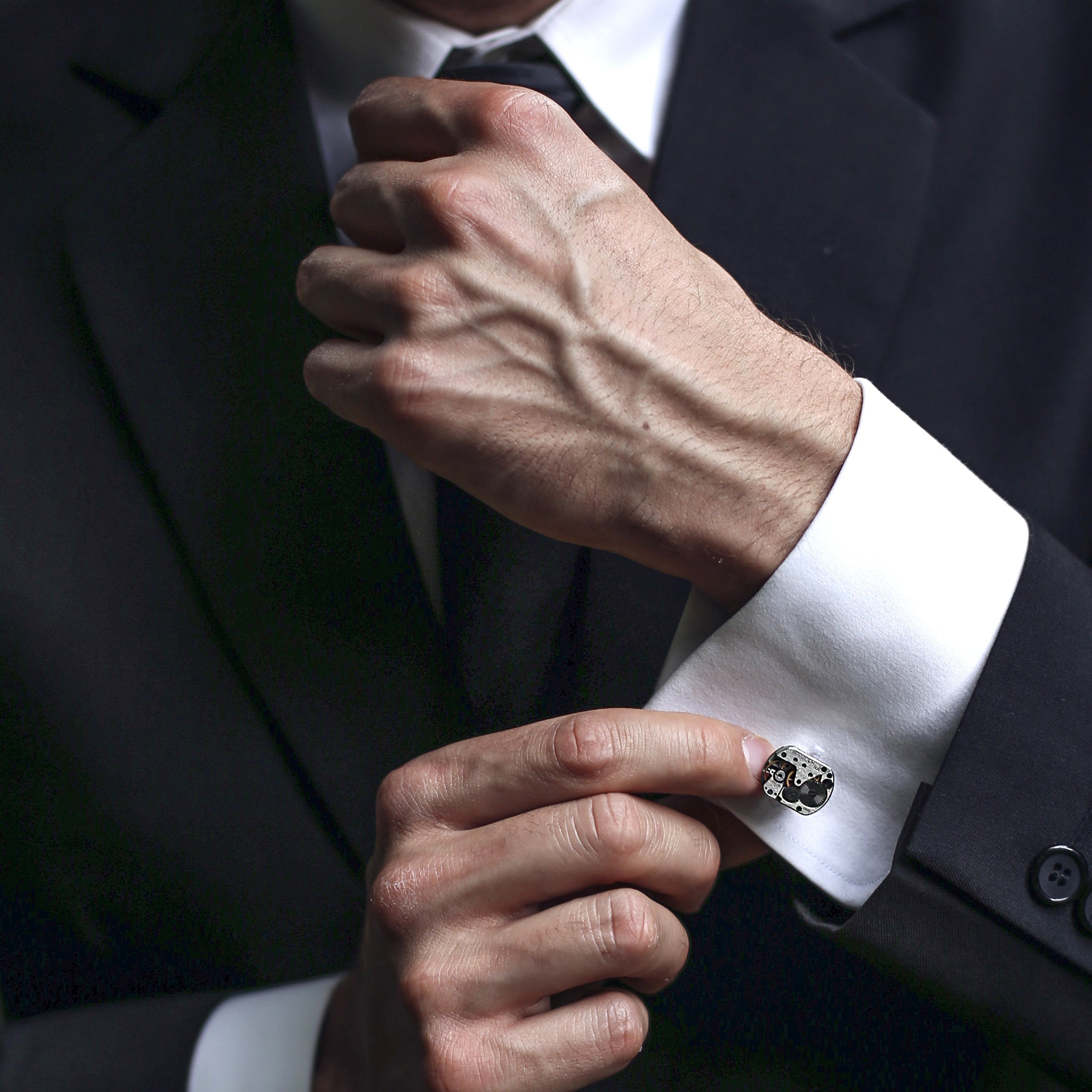 Groom wearing steampunk Cufflinks featuring antique watch movements in a gift box
