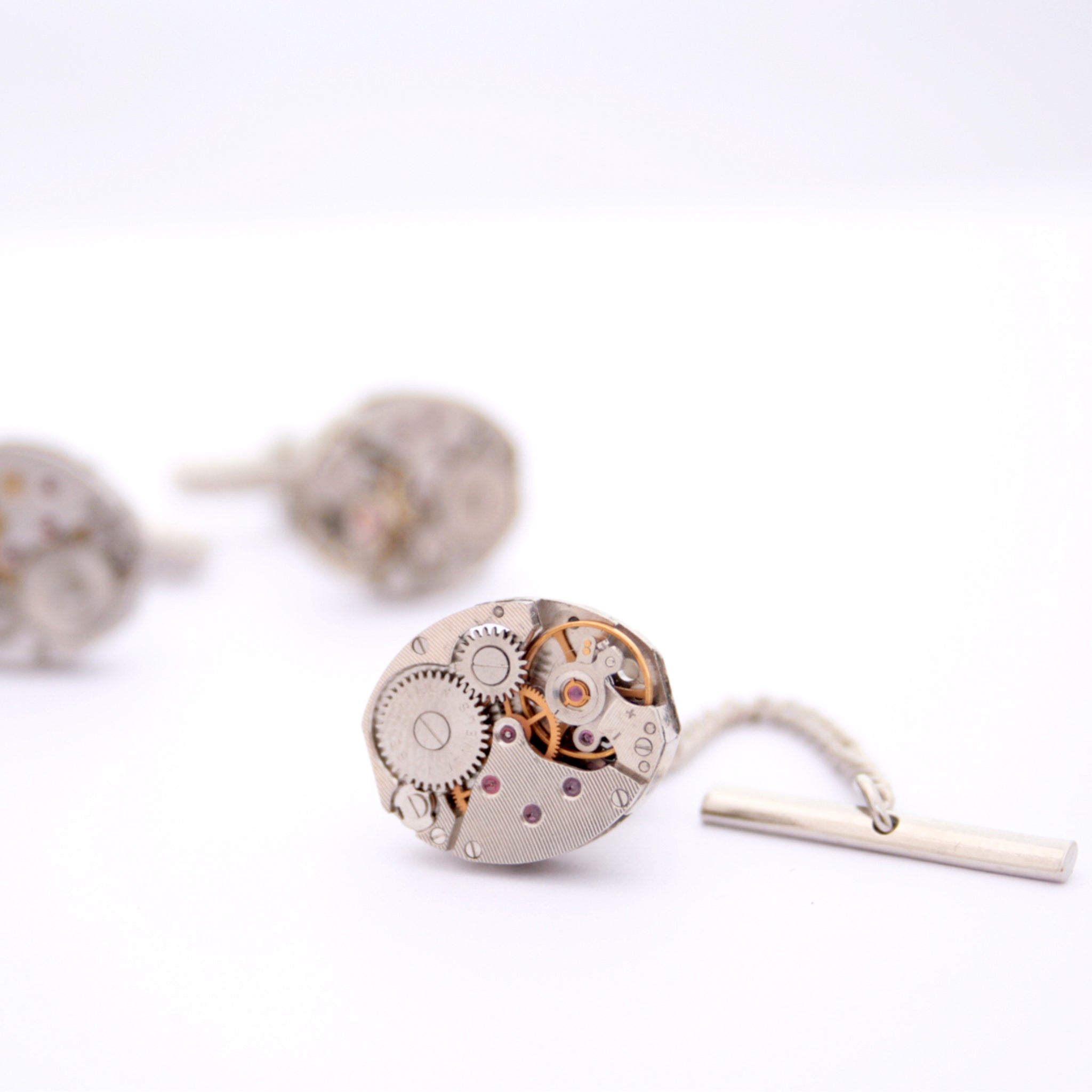 Tie Tack featuring old clock parts