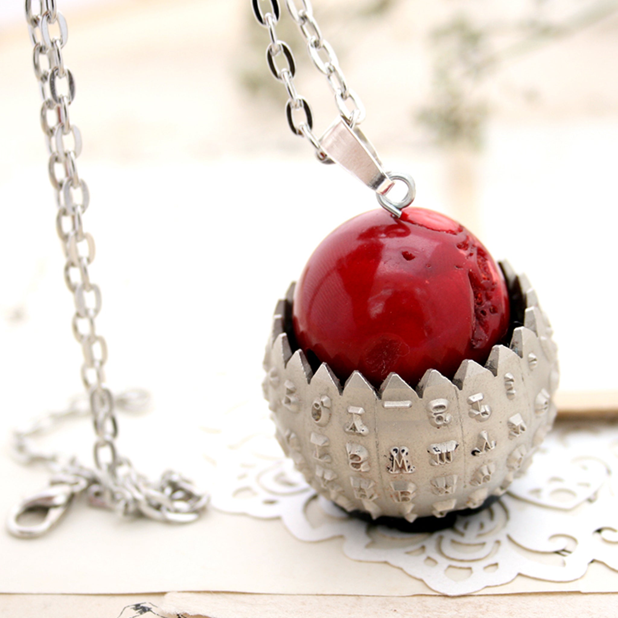 IBM Selectric typewriter font ball with large coral bead turned into eye catching necklace