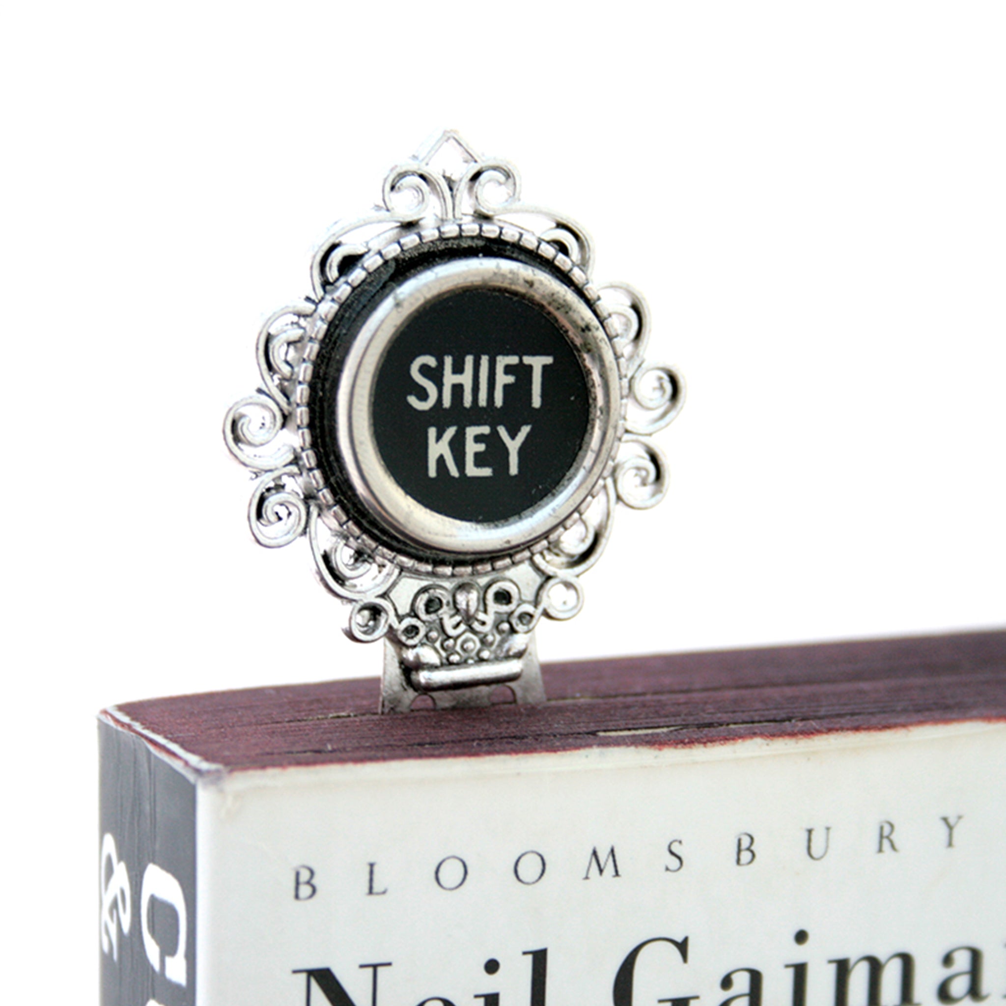 Metal bookmark made of real Shift Key from the typewriter in a book