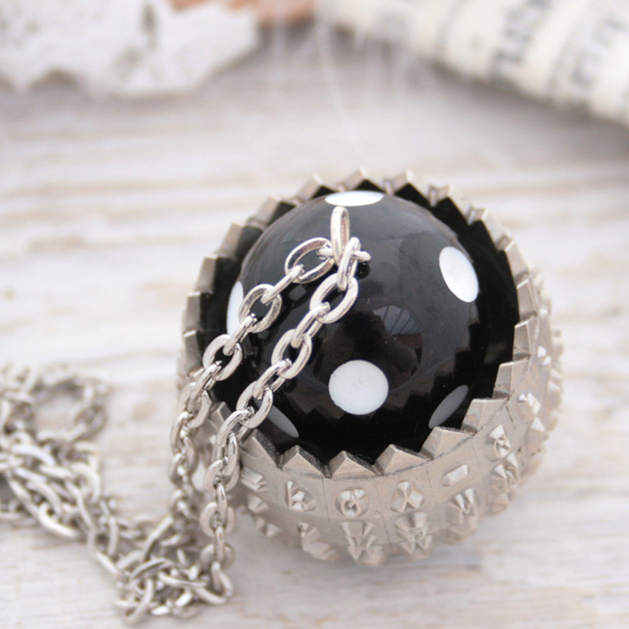 IBM Selectric typewriter font ball with large black and white bead turned into a necklace