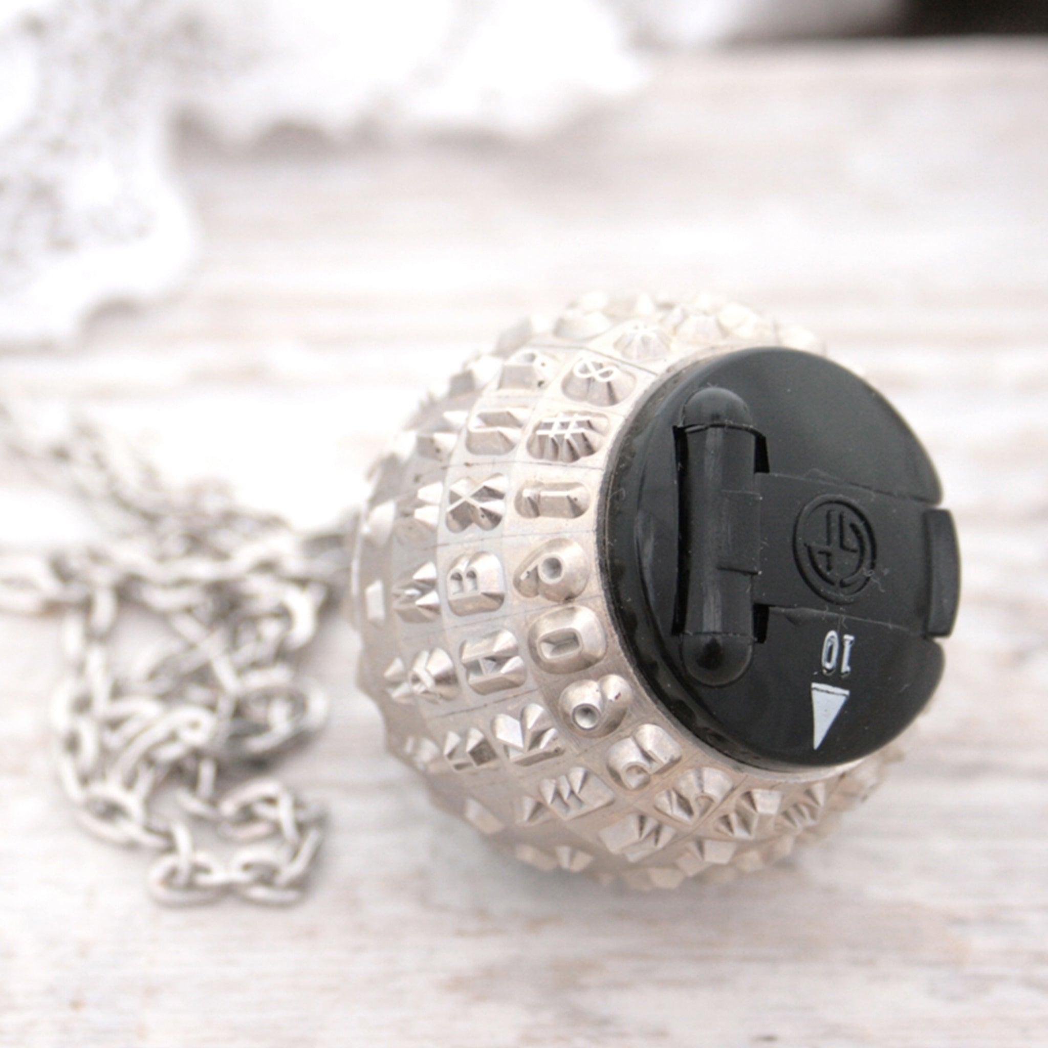 IBM Selectric typewriter font ball with large black and white bead turned into a necklace