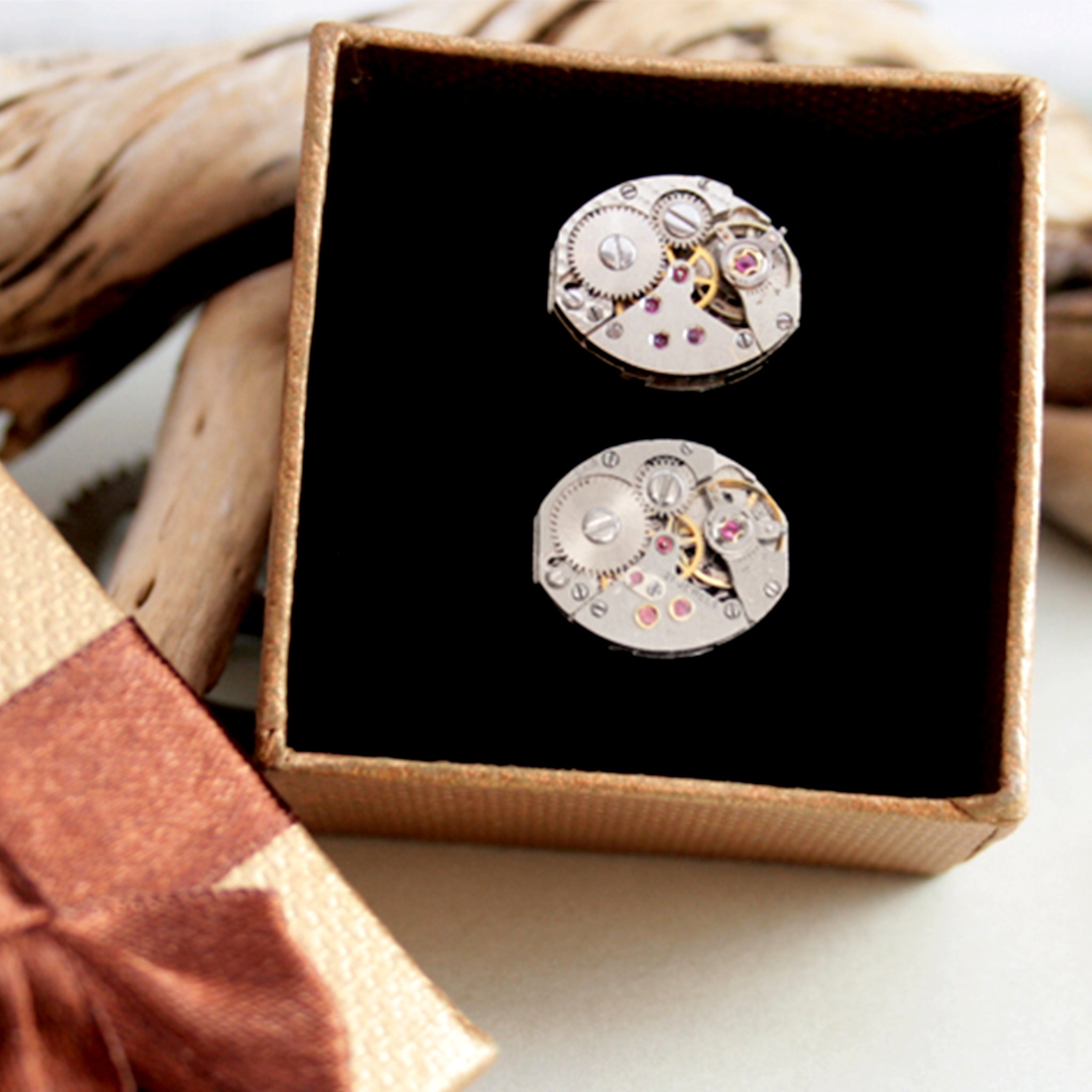 steampunk womens cufflinks featuring antique watch movements in a brown box