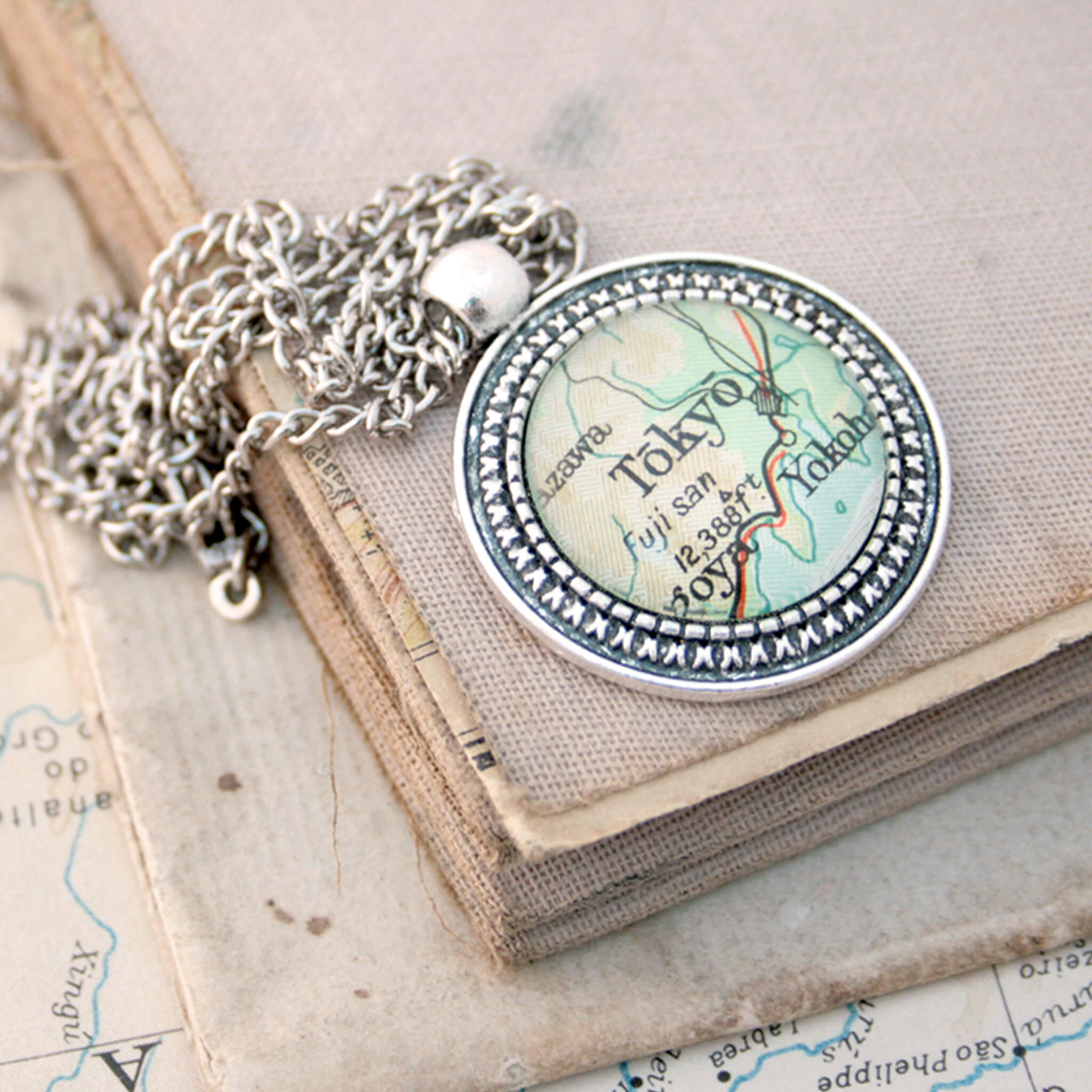 Silver coloured pendant necklace with map of Tokyo