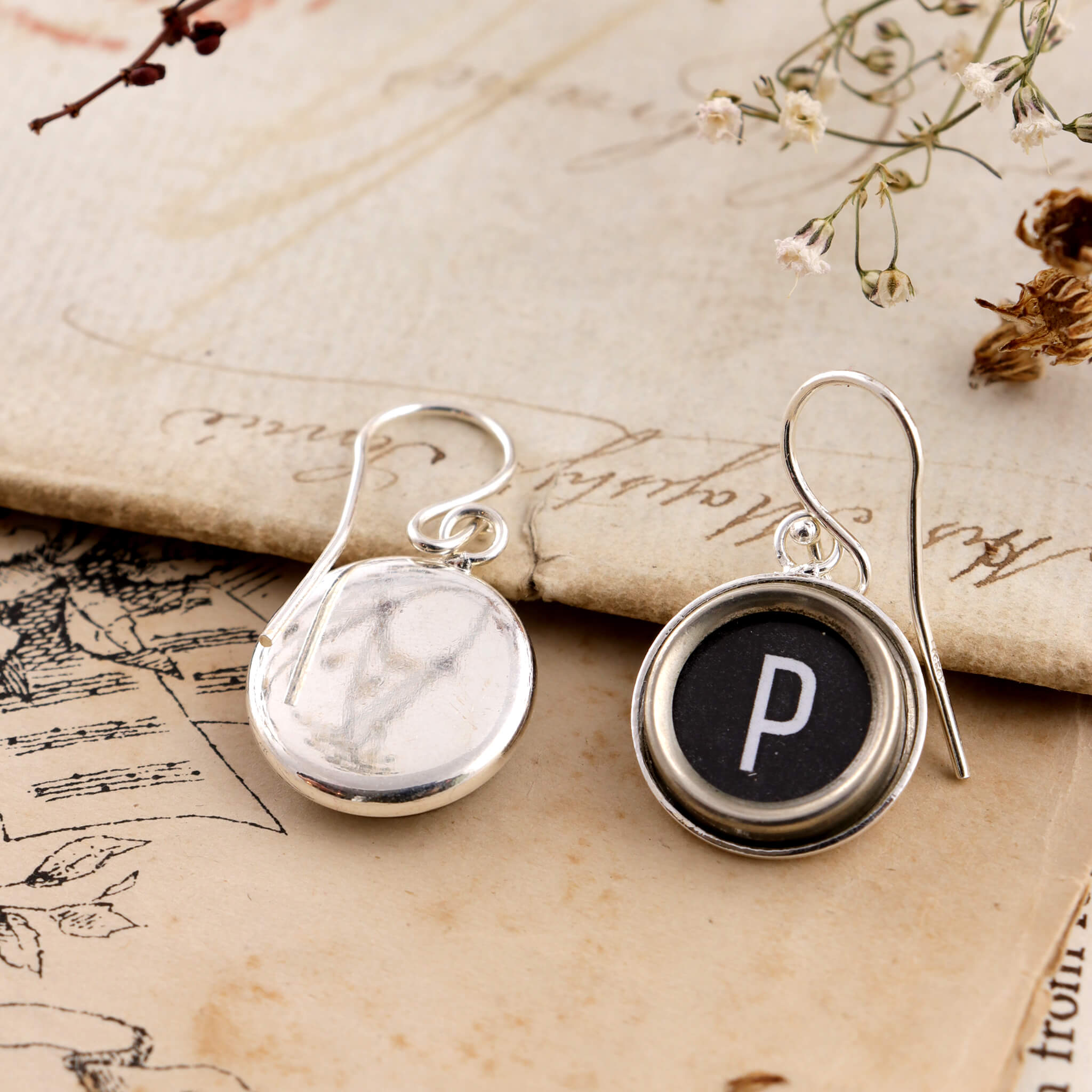 Black initial earrings P made of old typewriter keys one is turned