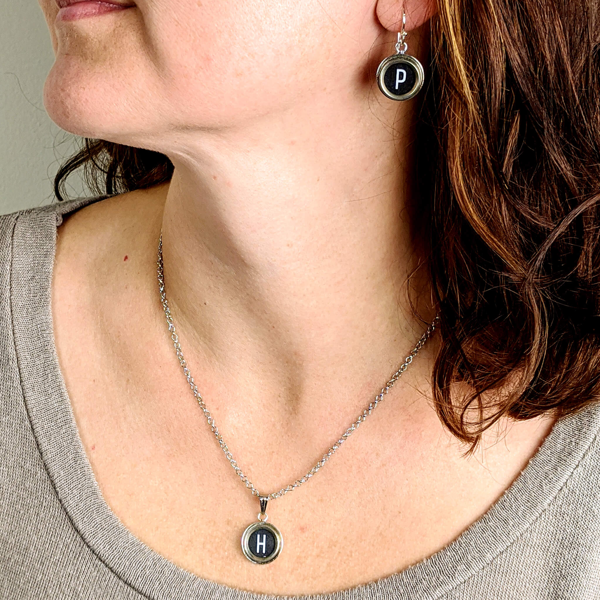 Woman wearing typewriter key necklace and earrings