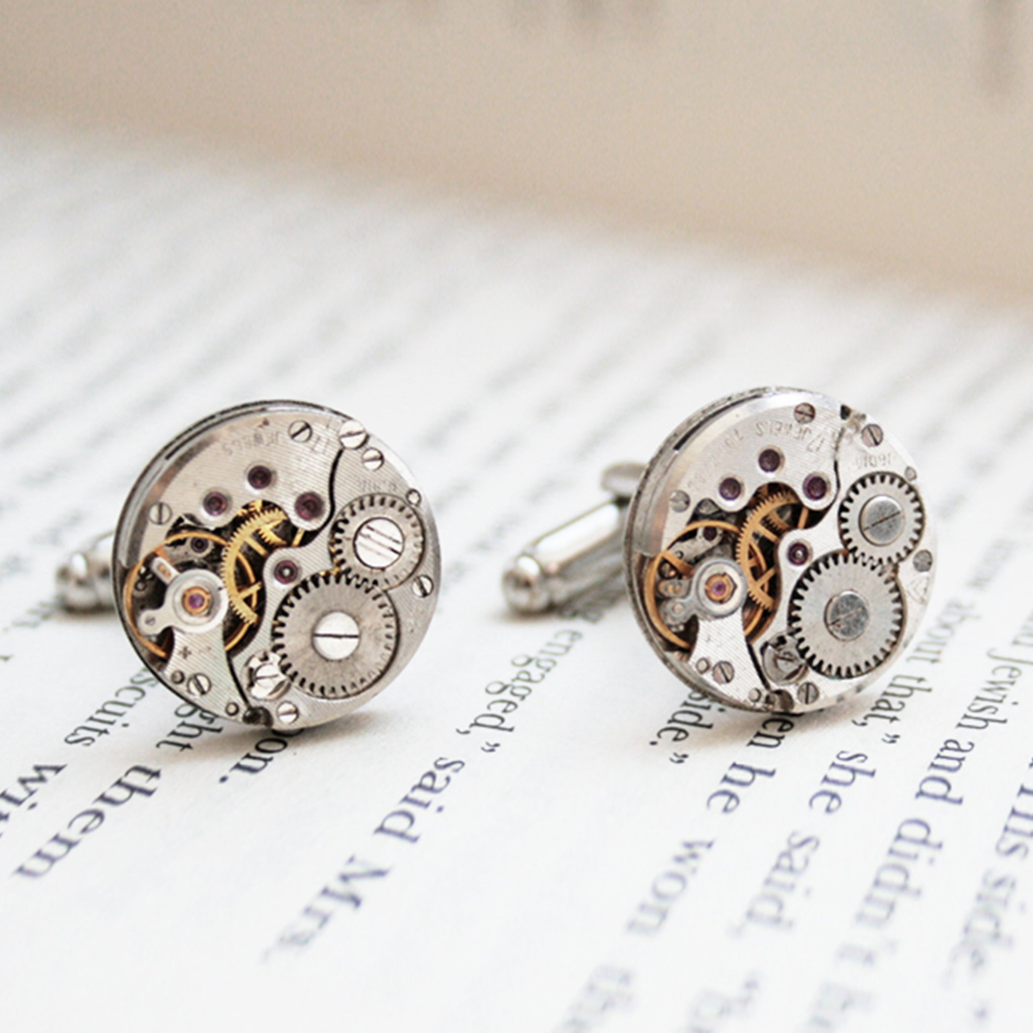 Round watch cufflinks in steampunk style featuring antique watch movements