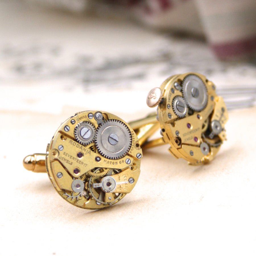 gold steampunk cufflinks featuring antique watch movements in a shift cuff