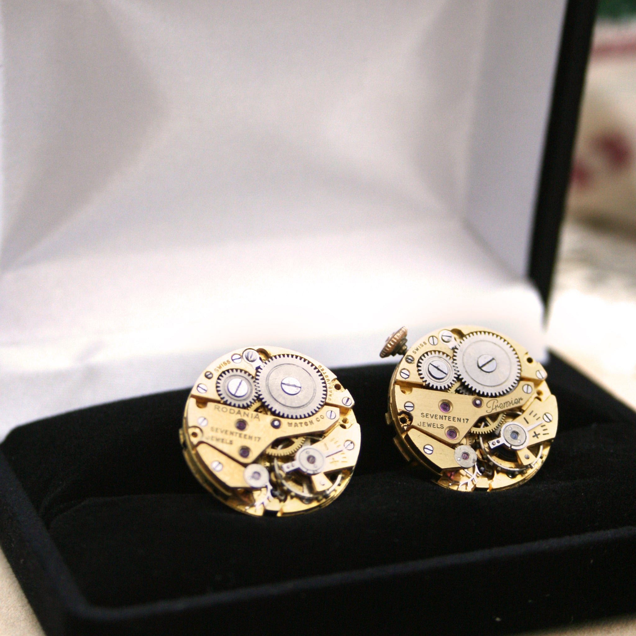 gold steampunk cufflinks featuring antique watch movements in a presentation box