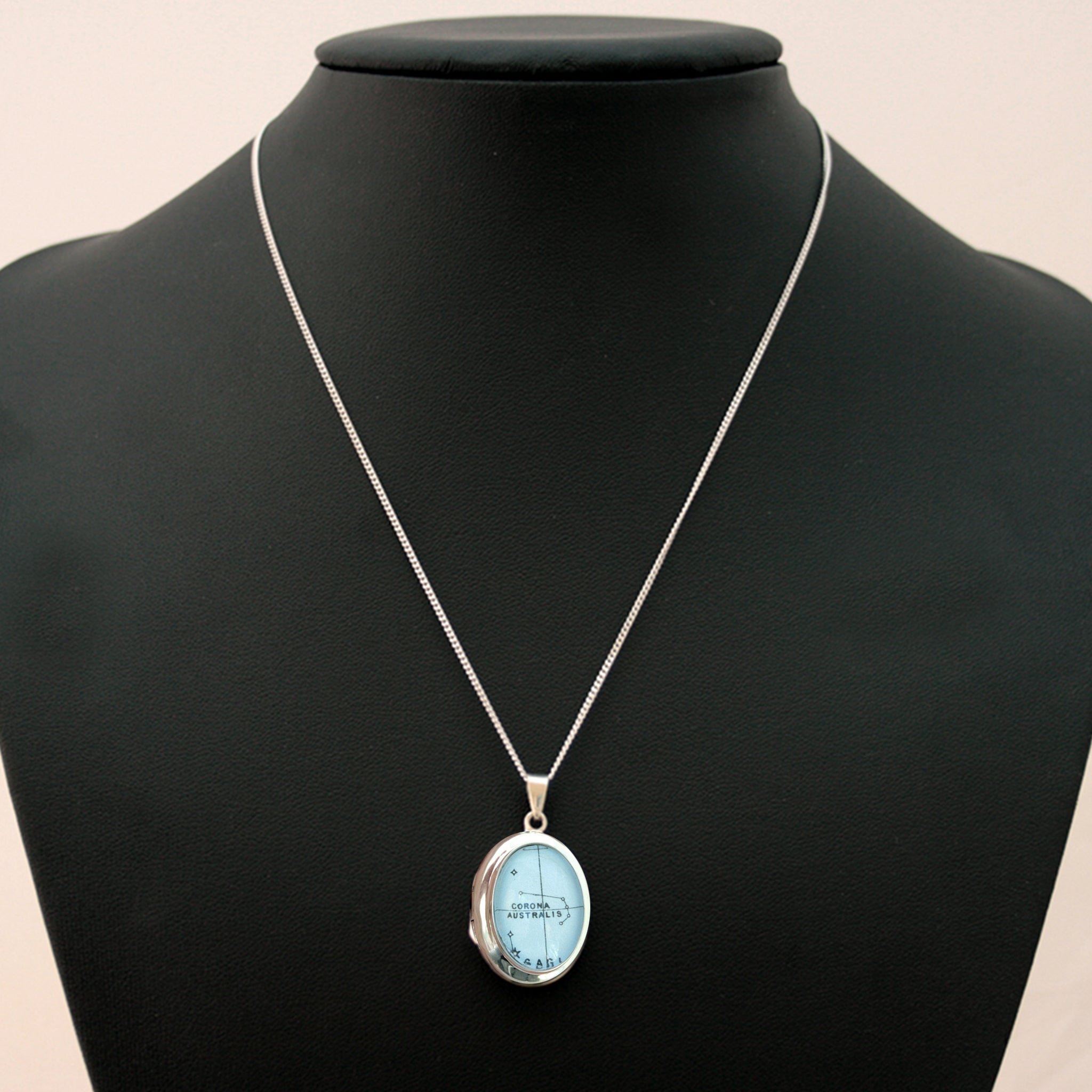 Sterling Silver locket necklace featuring Corona Australis star constellation on a black torso