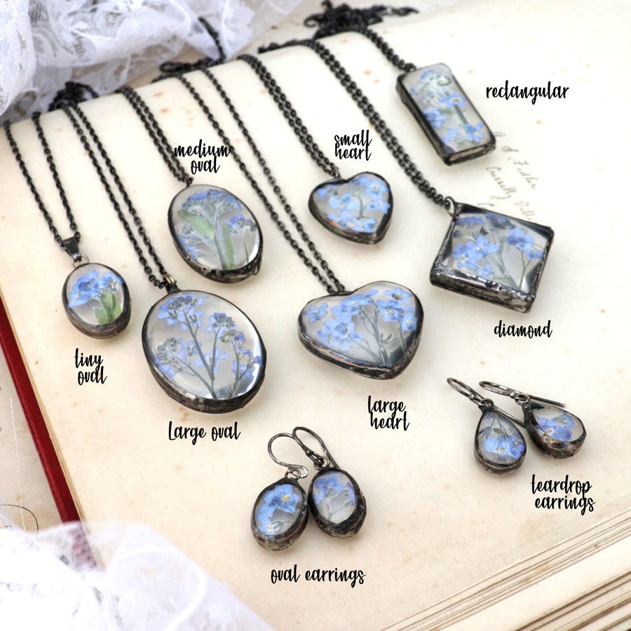  Forget-me-not necklaces lying one by another