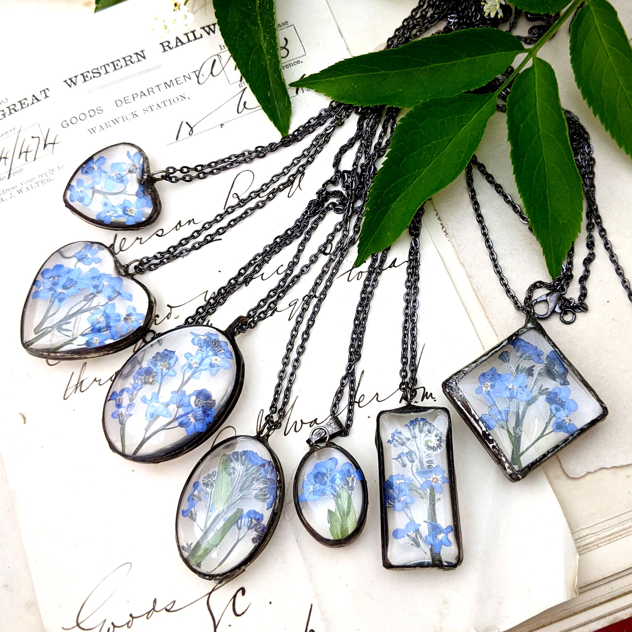  Forget-me-not necklaces lying one by another