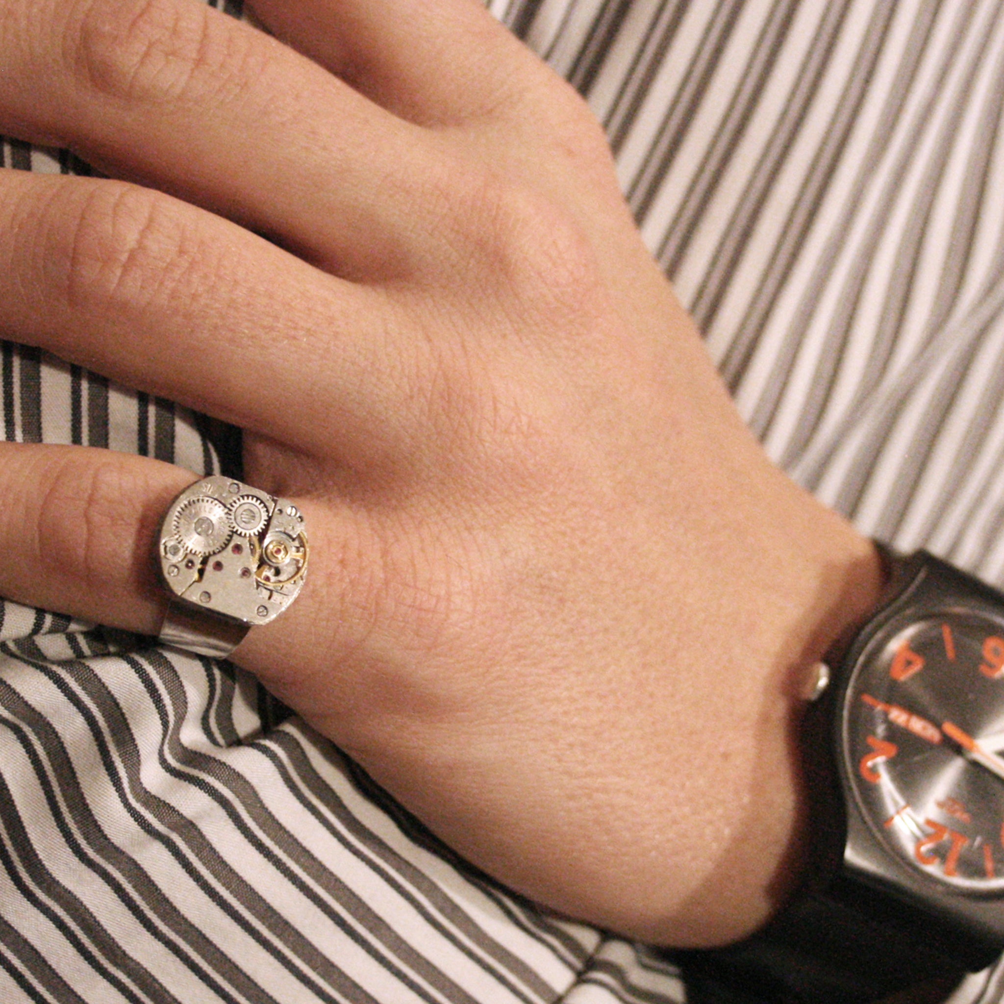 Man wearing pinky Ring in Steampunk Style made of watch mechanism