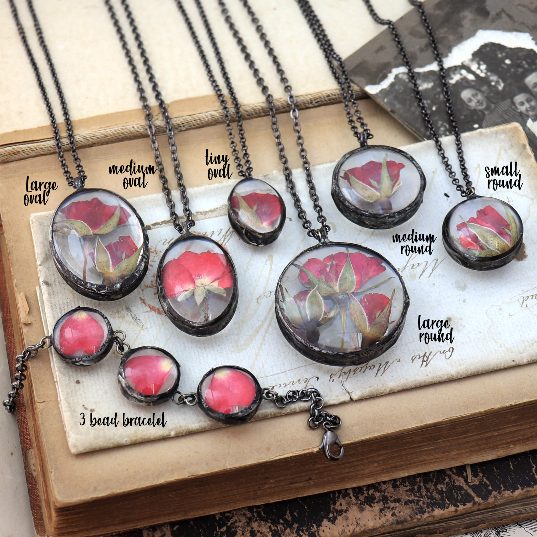 A few pieces of jewellery, mostly necklaces lying one next to another on an old book