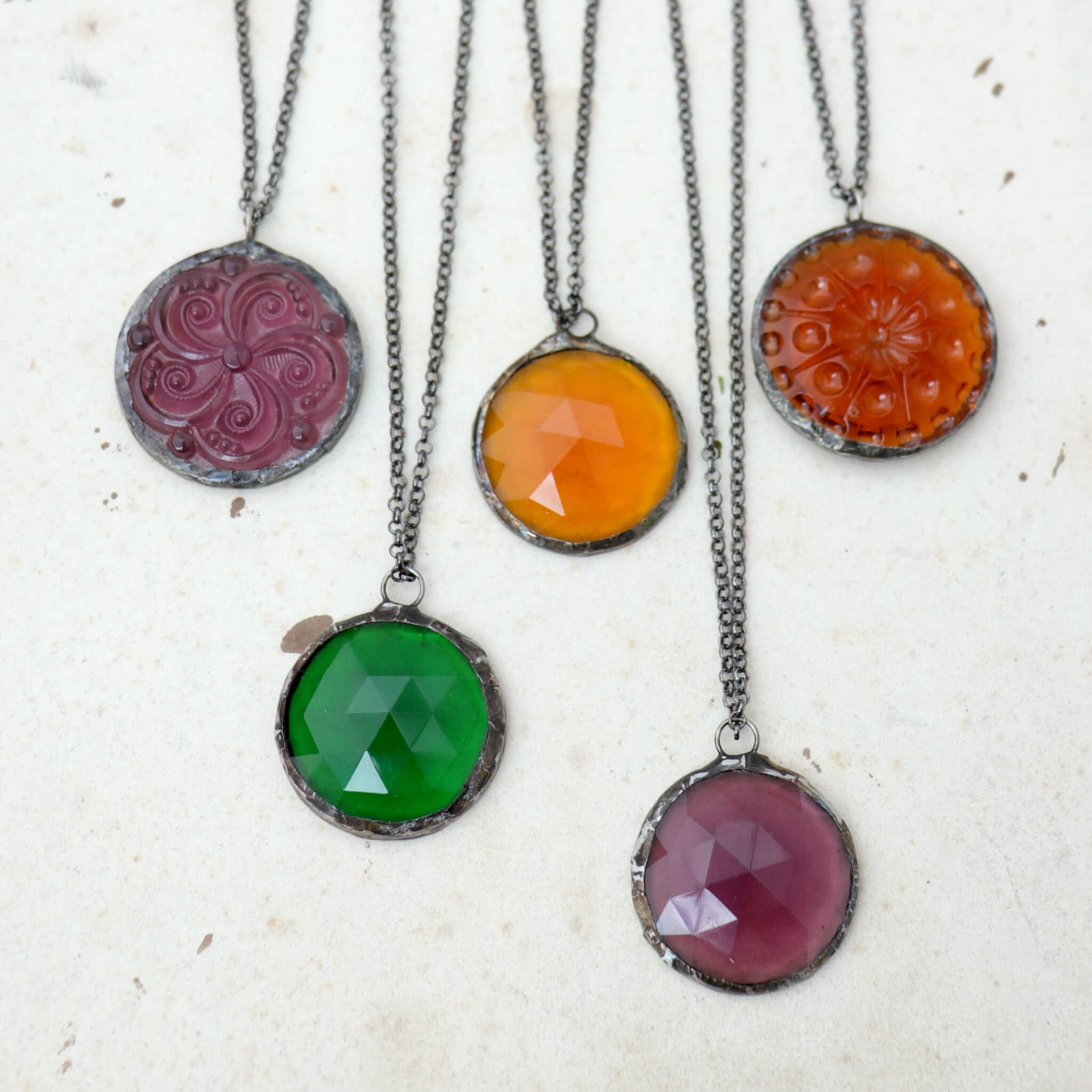 Amethyst, emerald and amber glass soldered into stained glass necklaces
