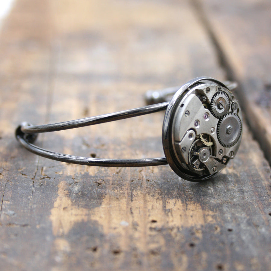 Steampunk open bangle bracelet in gunmetal black tones.