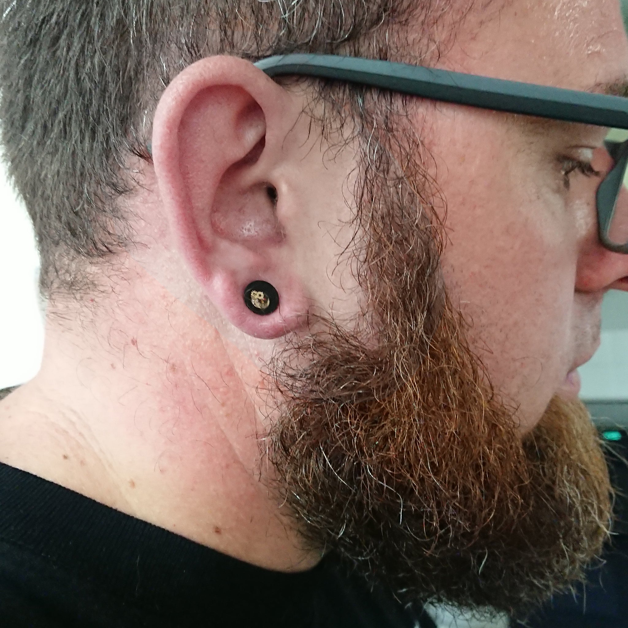 Man wearing 10mm steampunk ear gauges