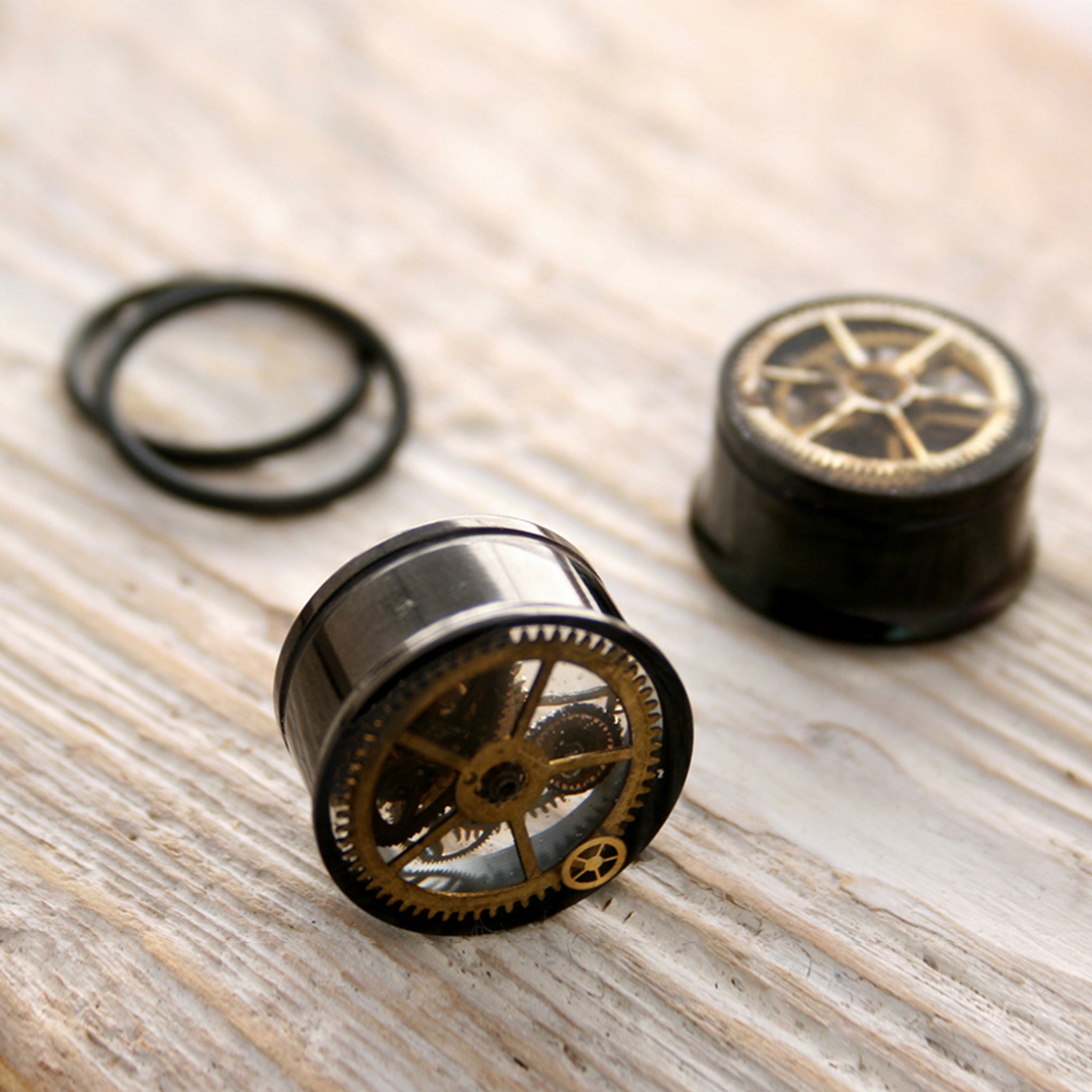 Black steampunk plug earrings with real watch parts in resin with o-rings