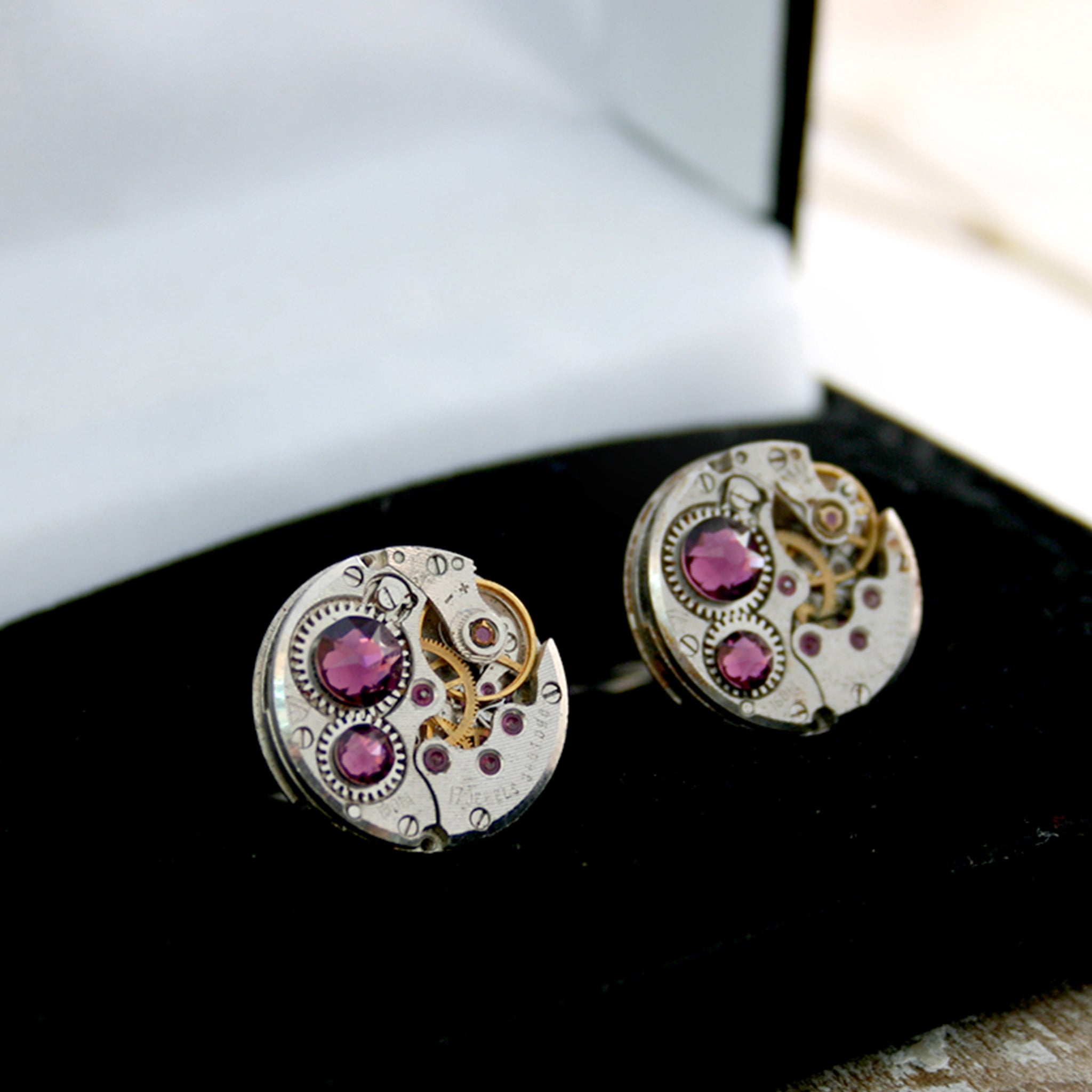  birthstone cufflinks in steampunk style featuring antique watch movements and Amethysts in a box
