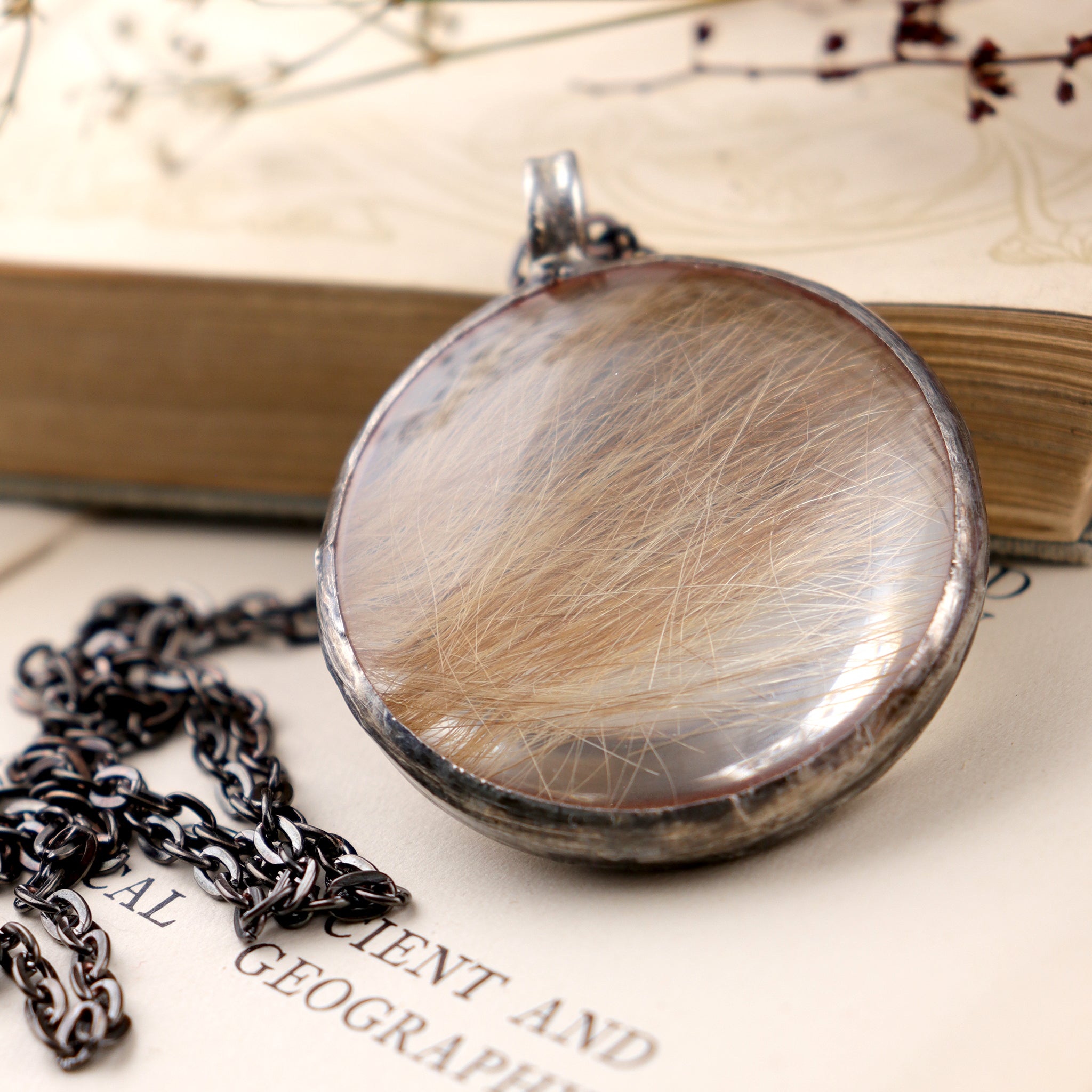 Baby hair necklace laying on an old book