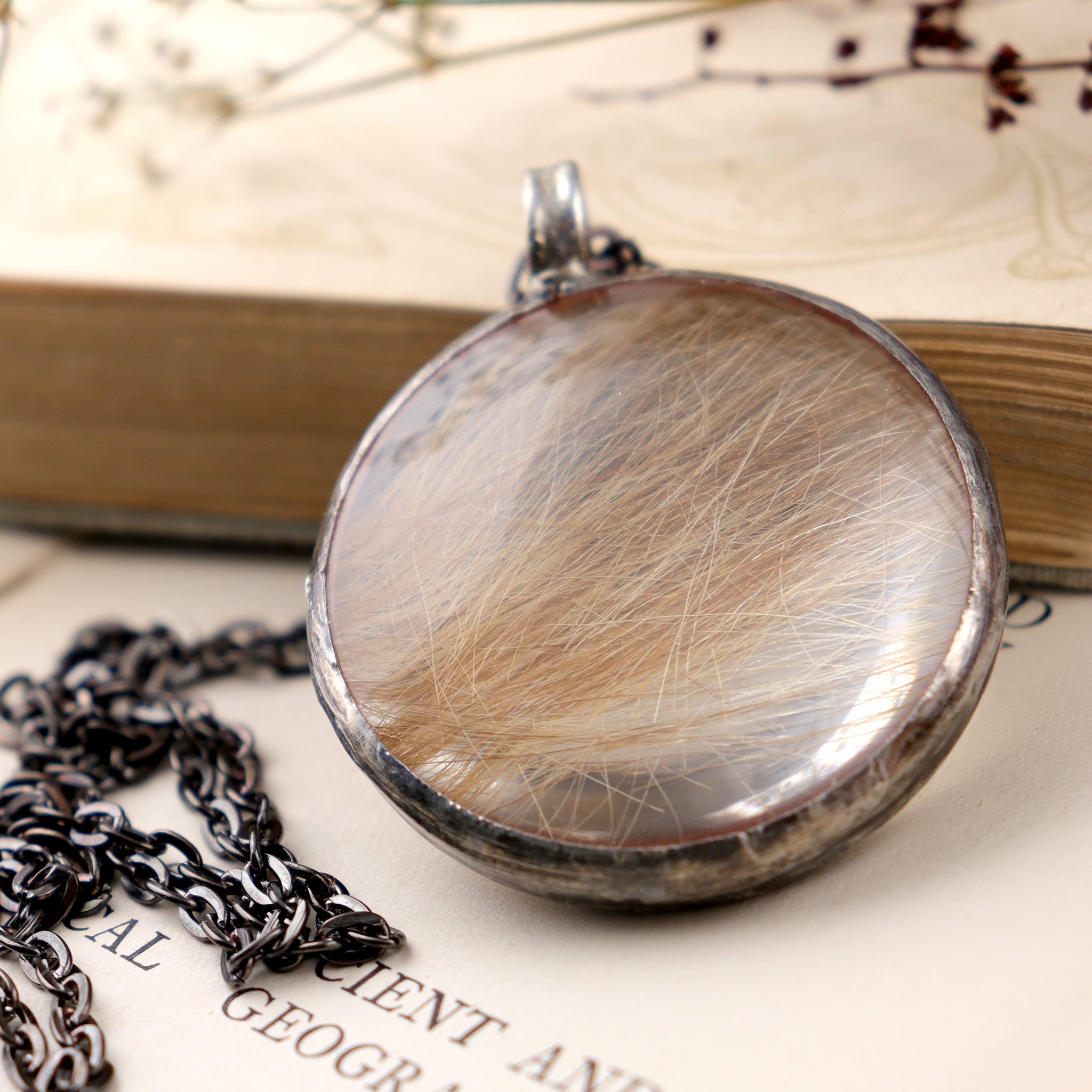 Baby hair necklace laying on an old book