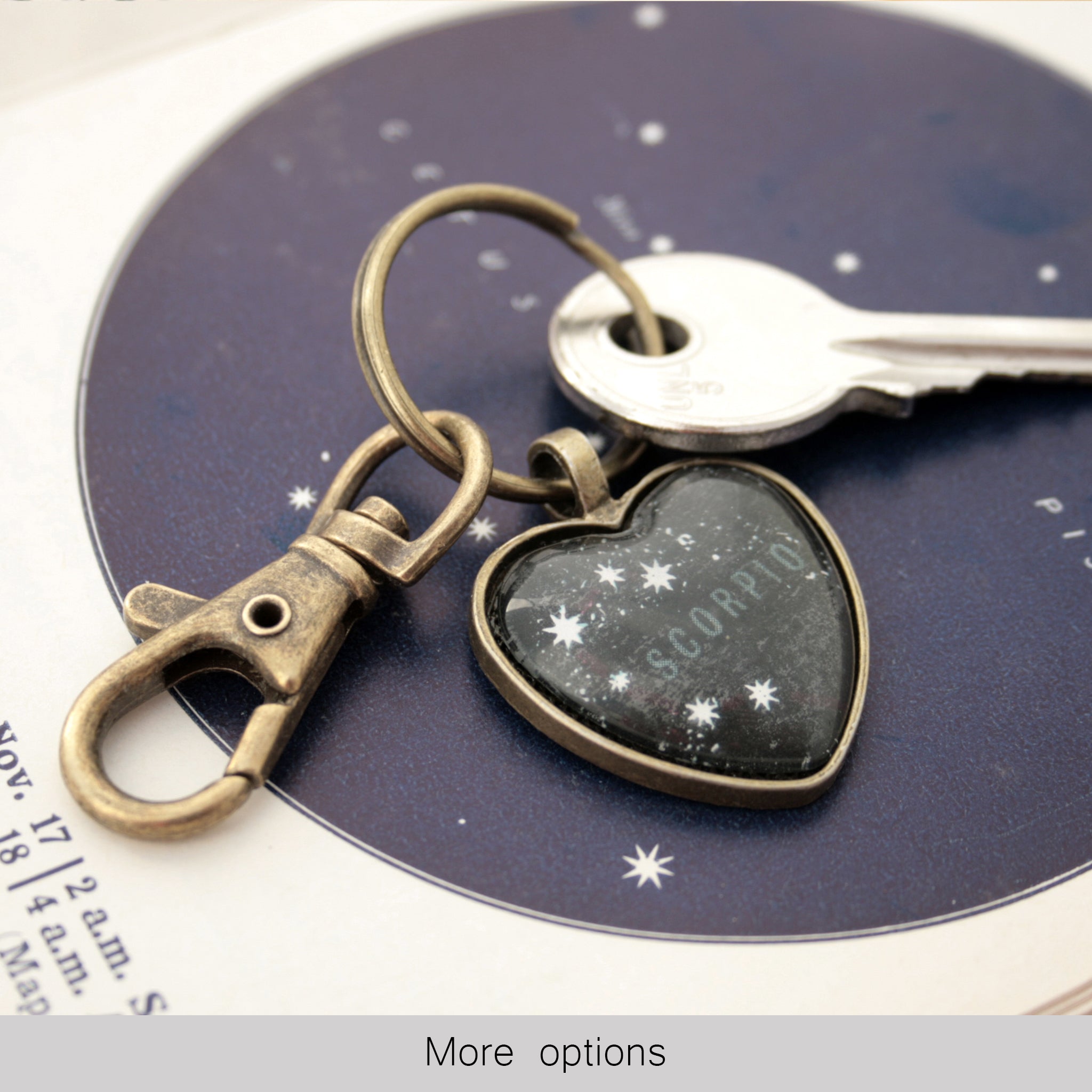 Heart shaped keychain featuring scorpio zodiac on black map