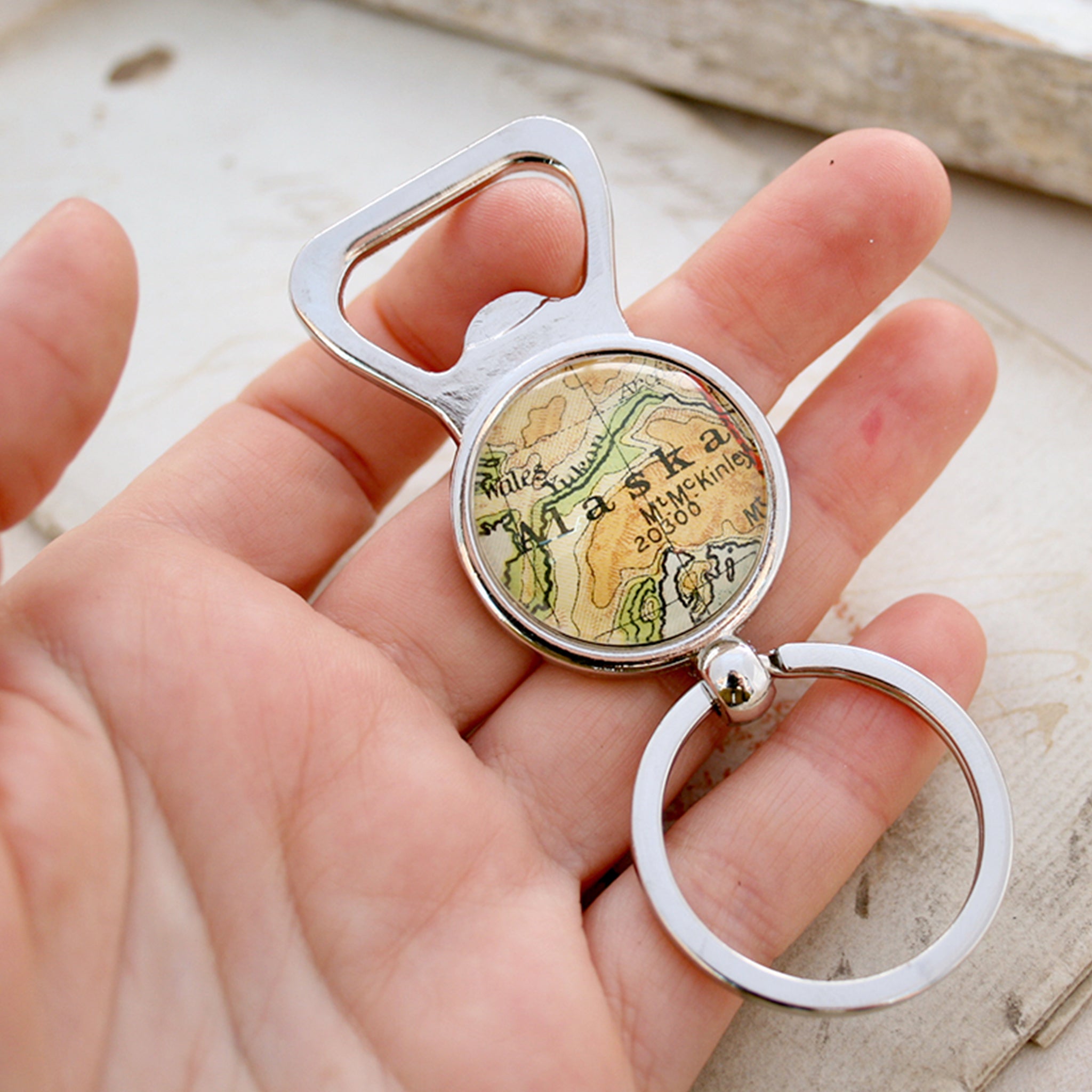 Hand holding personalised Bottle Opener with map of Alaska featured