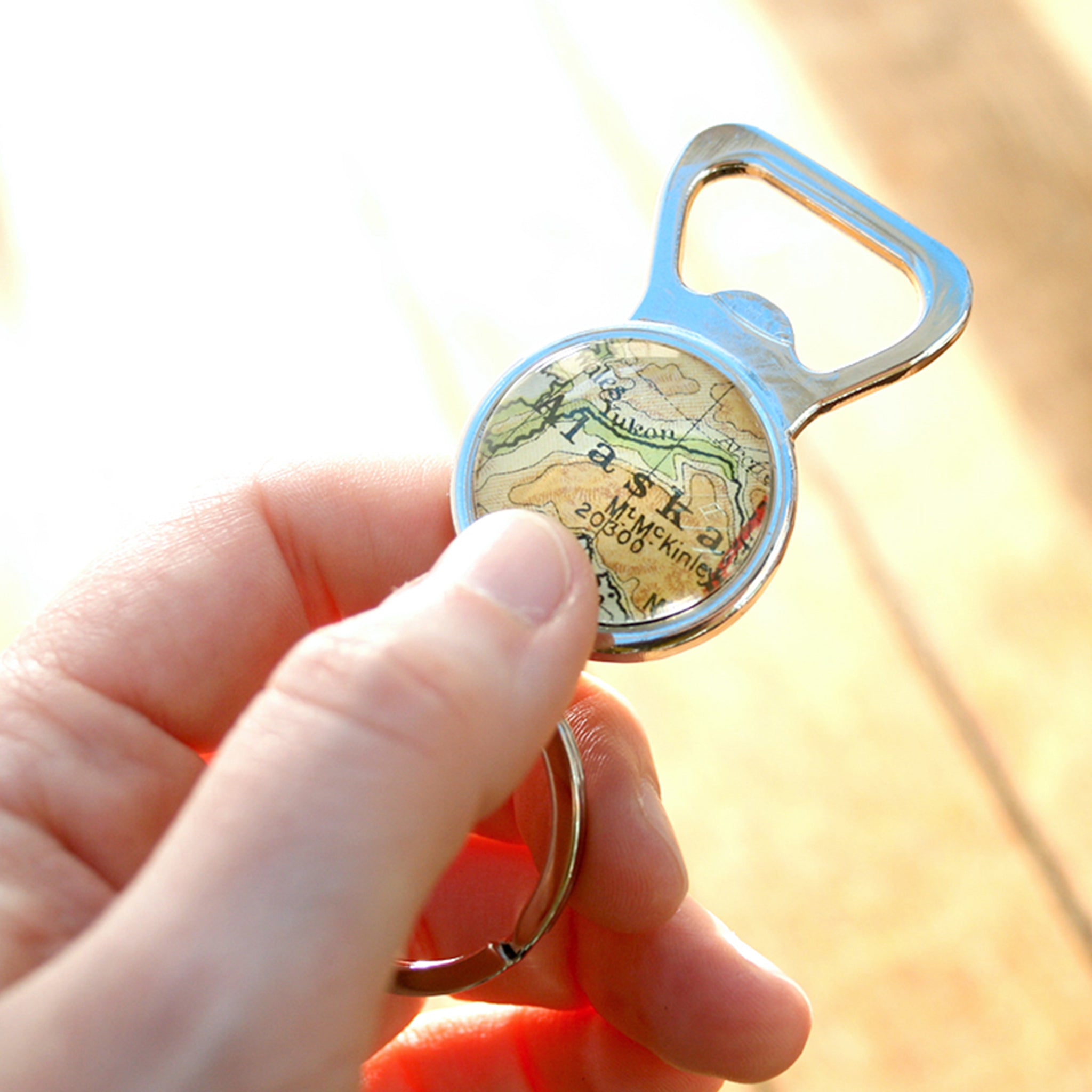 Hand holding personalised Bottle Opener with map of Alaska featured