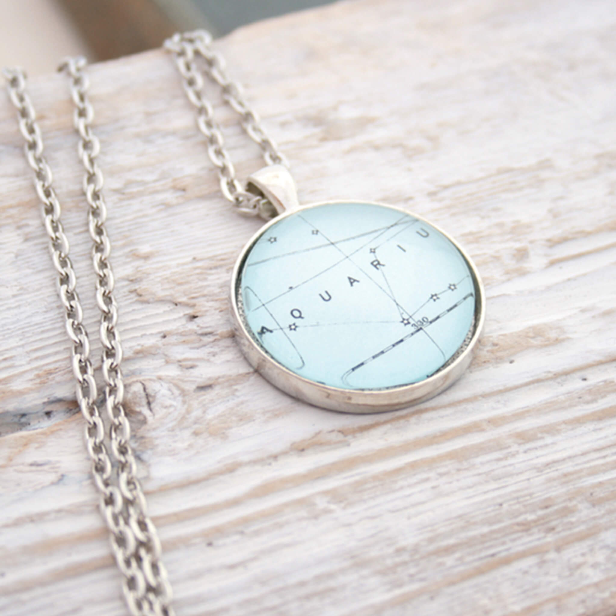 Silver tone pendant necklace featuring map of Aquarius constellation