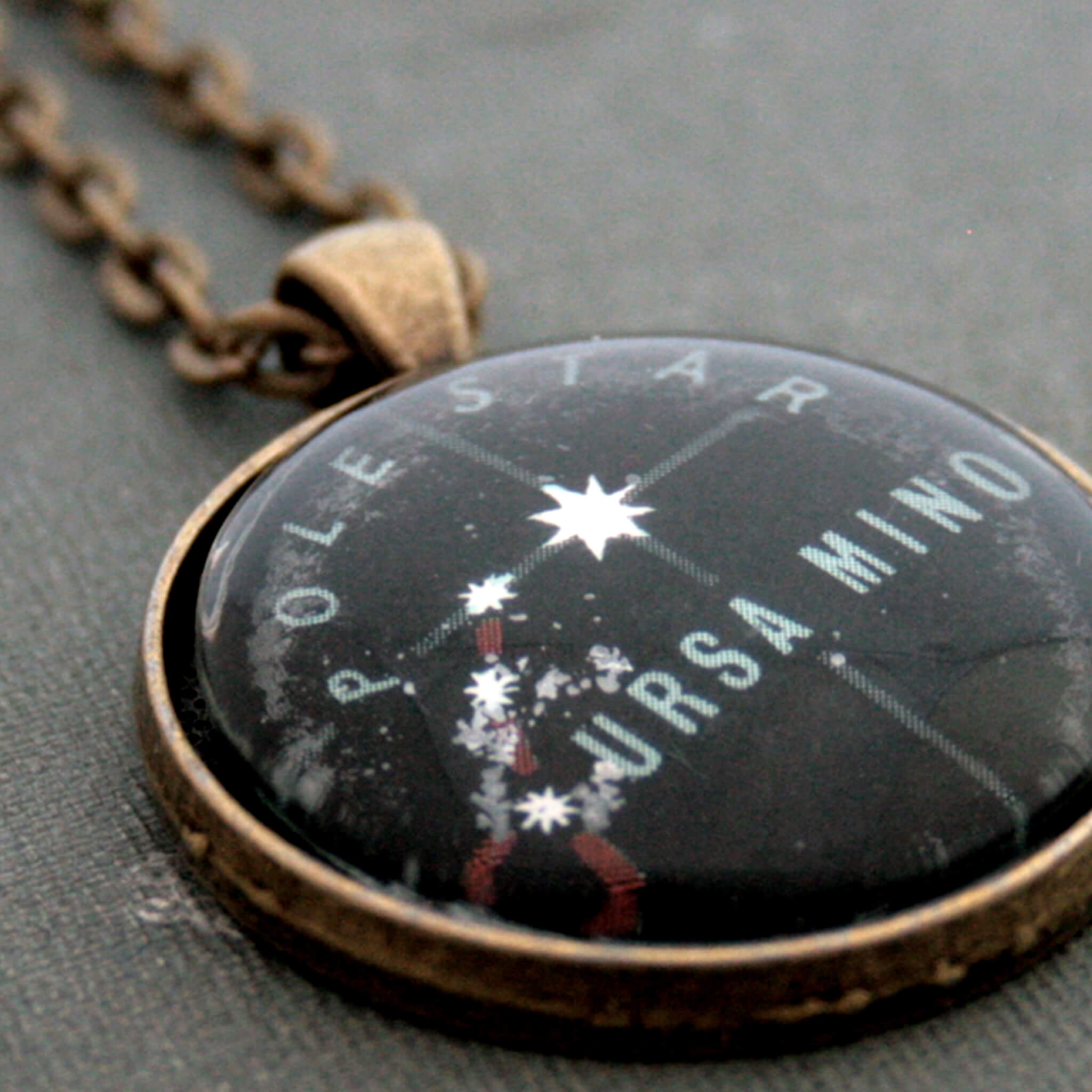 Bronze tone pendant necklace featuring map of Ursa Minor constellation with Polaris