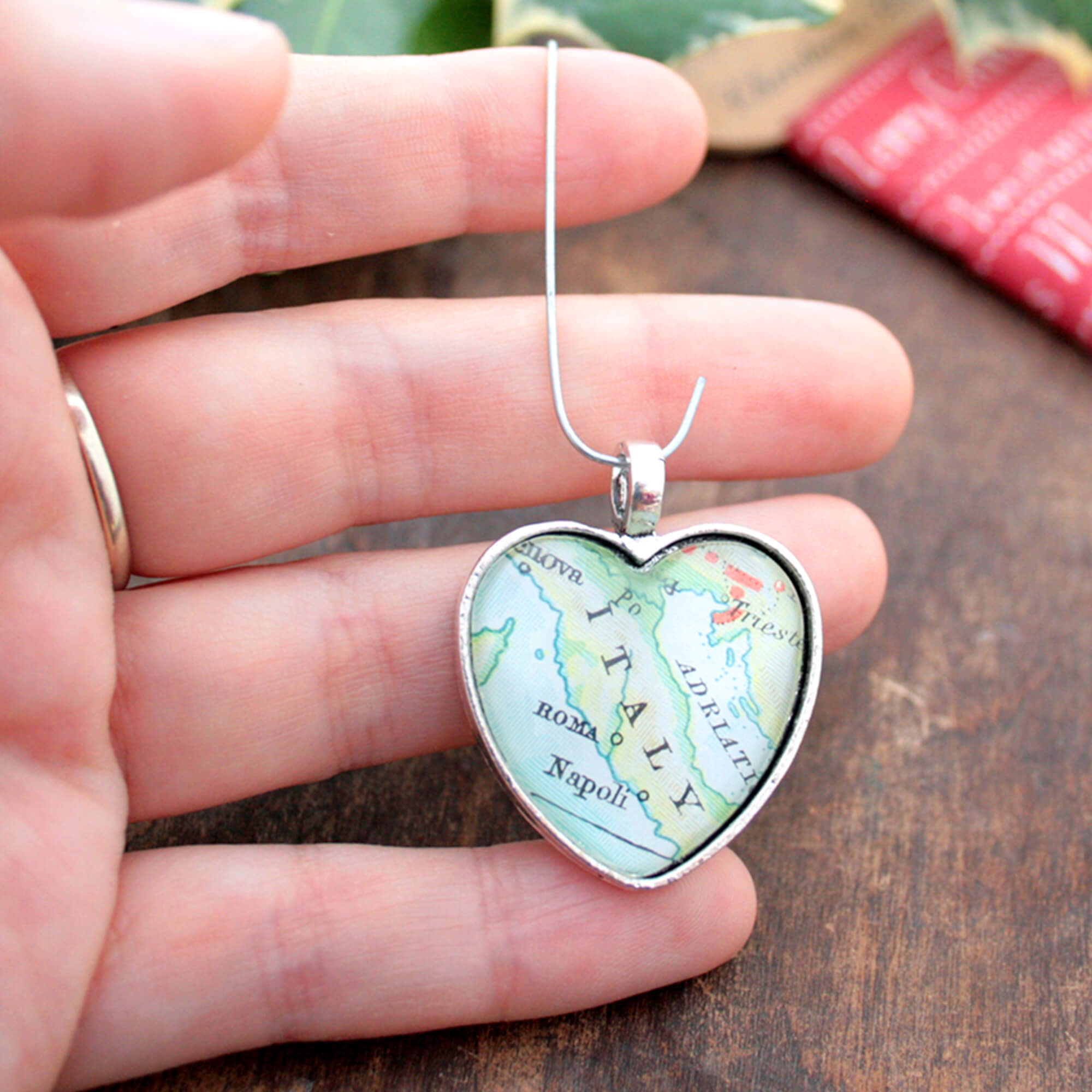 Christmas tree ornament in heart shape featuring map of the world