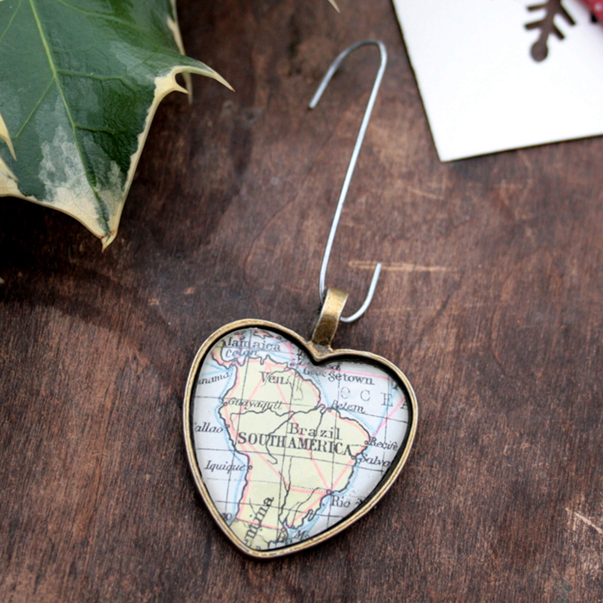 Christmas tree ornament in heart shape featuring map of the world