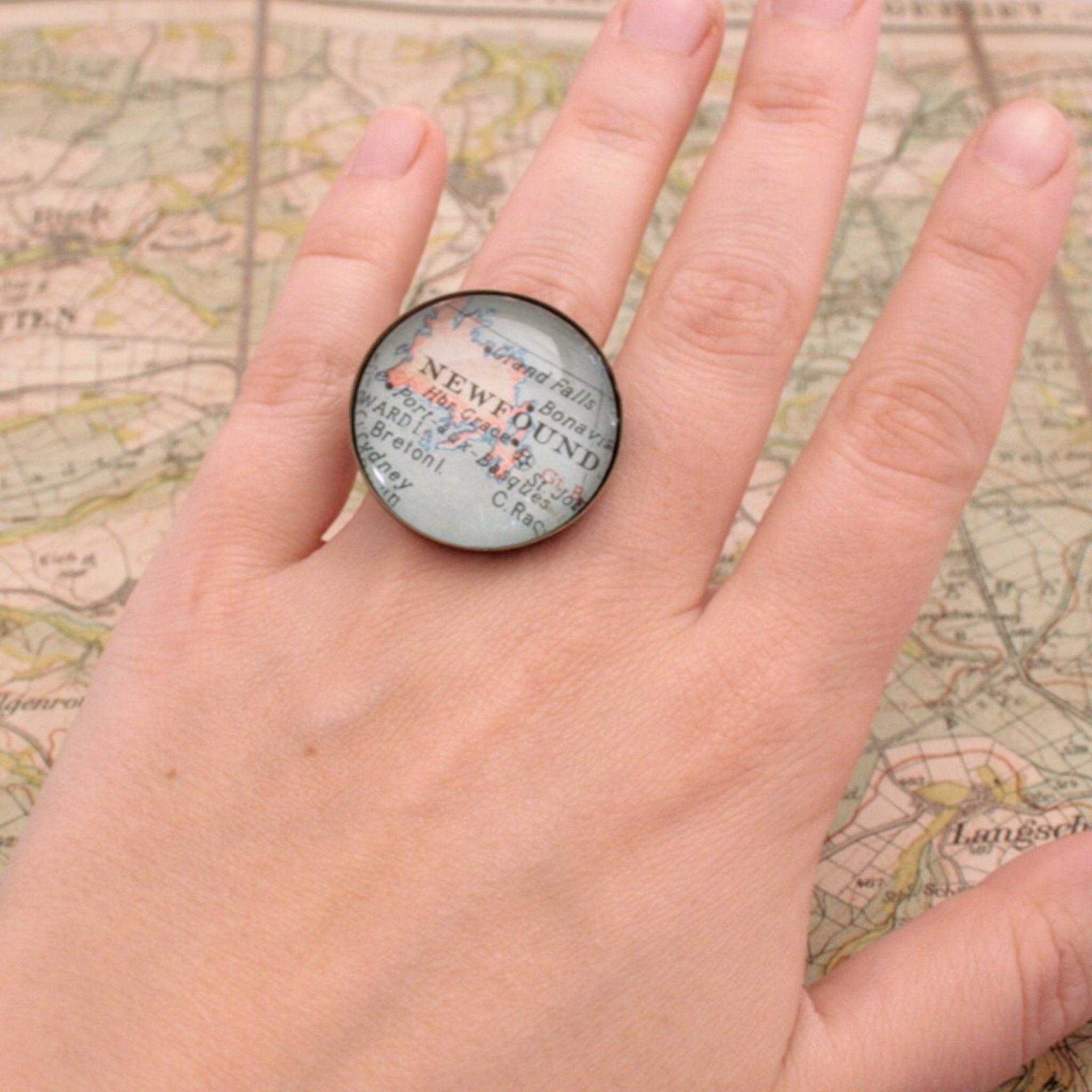 Round bronze ring personalised with custom map of Newfoundland worn on hand