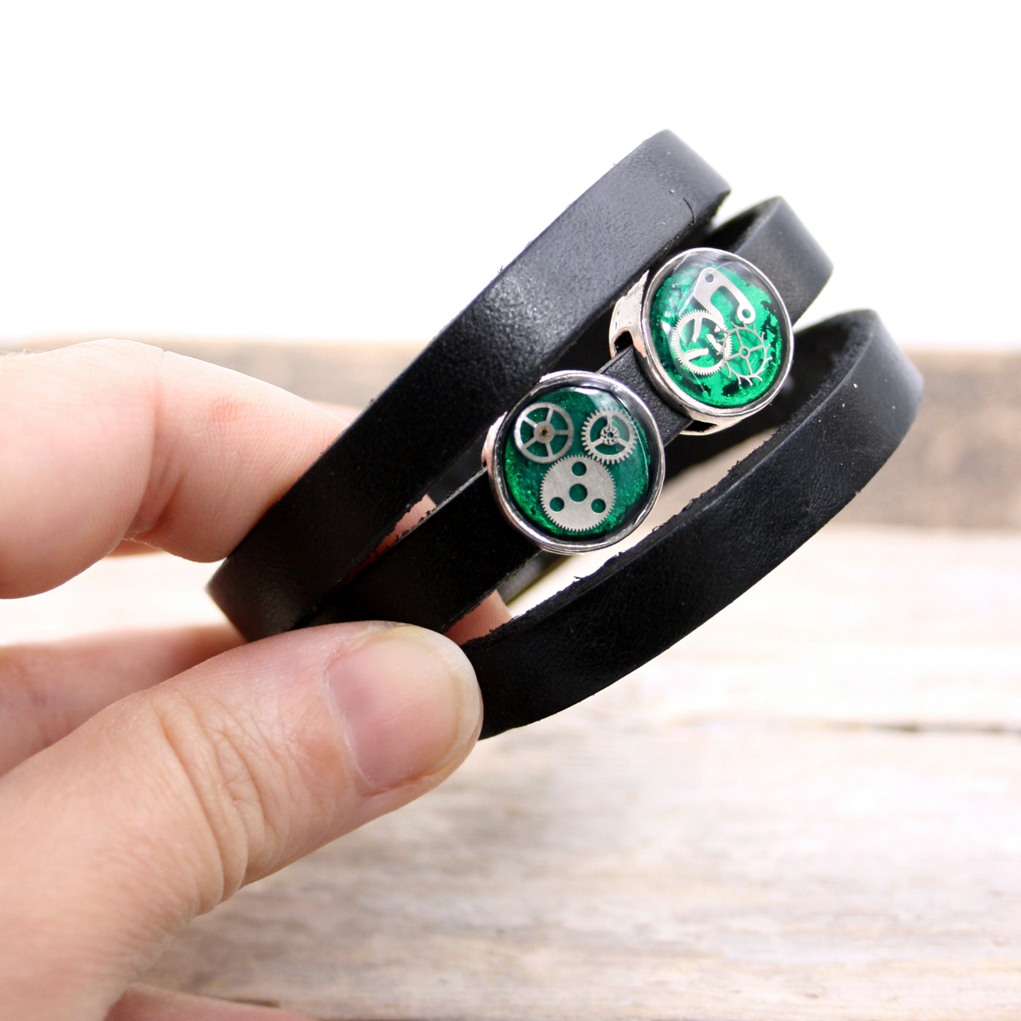 Black leather triple wrap bracelet with green steampunk slider beads with watch parts