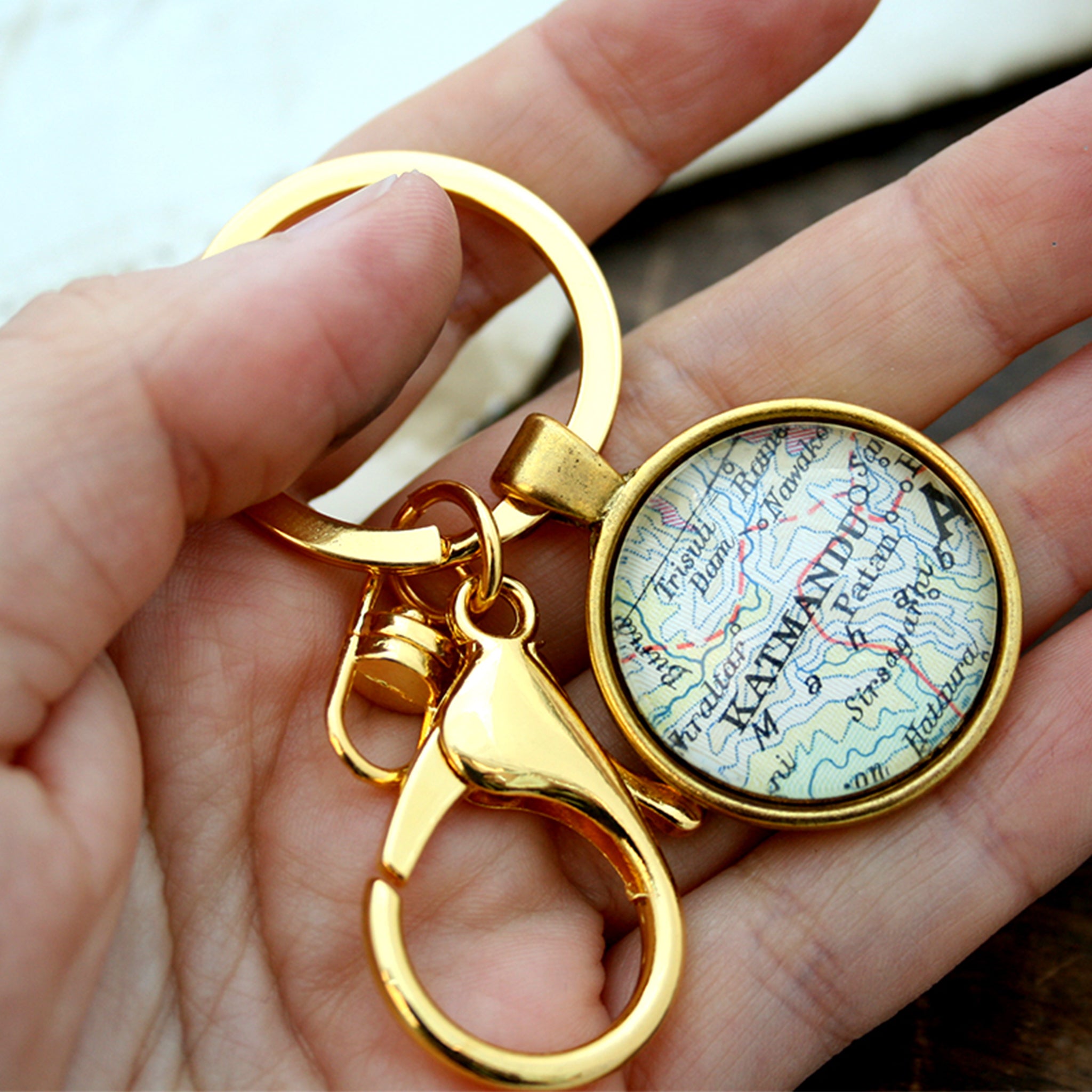 Hold in hand Personalised keyring in gold color featuring map of Kathmandu