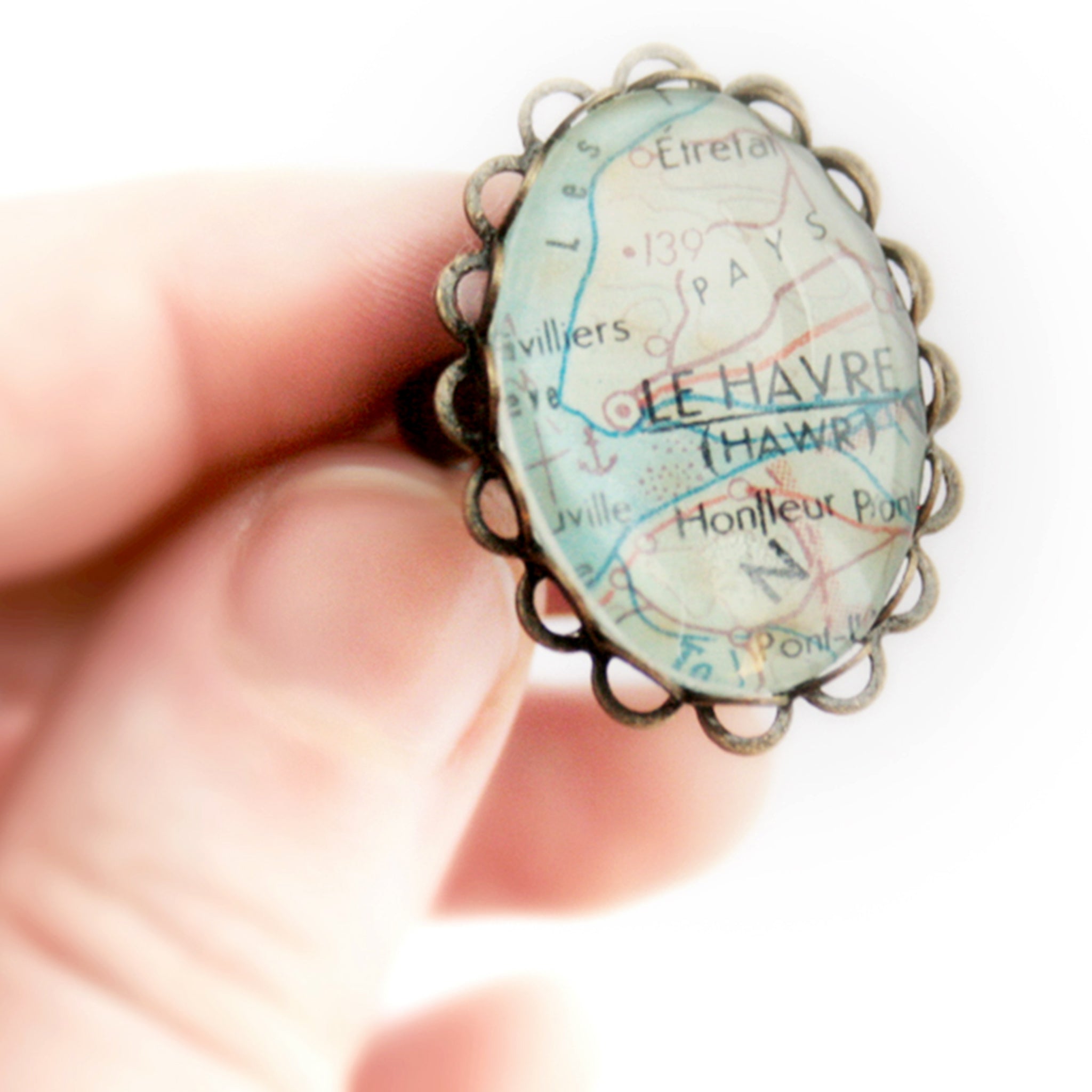 Hand holding Oval bronze personalised ring featuring map of Le Havre