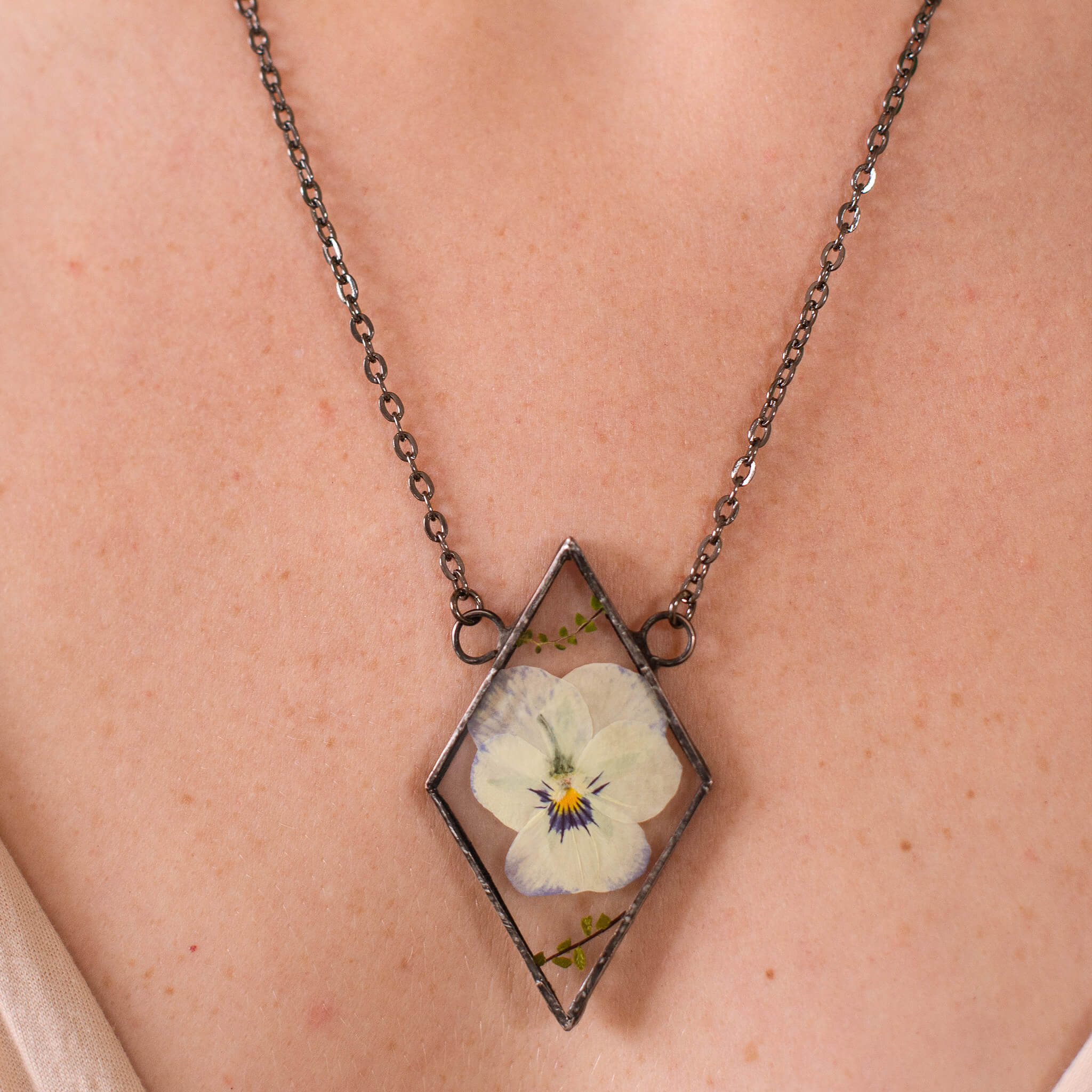 Pansy necklace worn on a cleavage