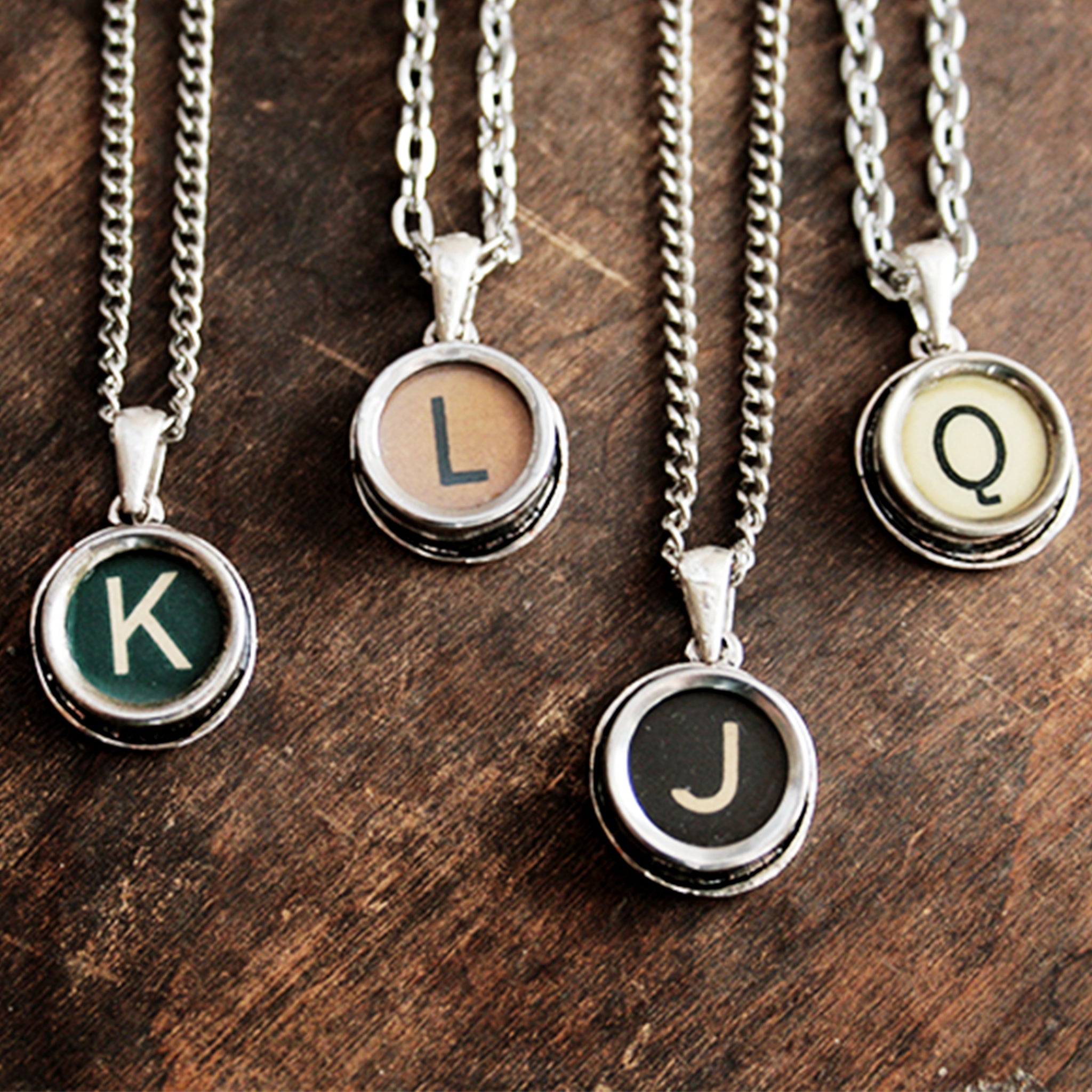Four typewriter necklaces made of real typewriter keys in green, brown, black and ivory color