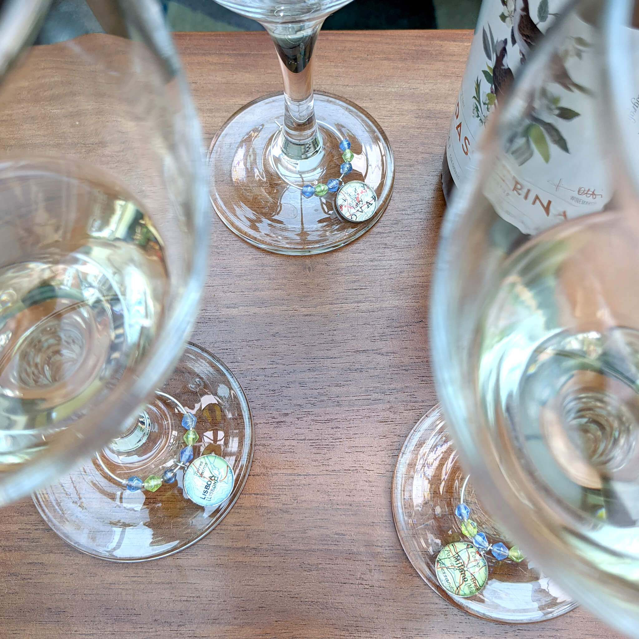 wine glasses with personalised charms with map locations