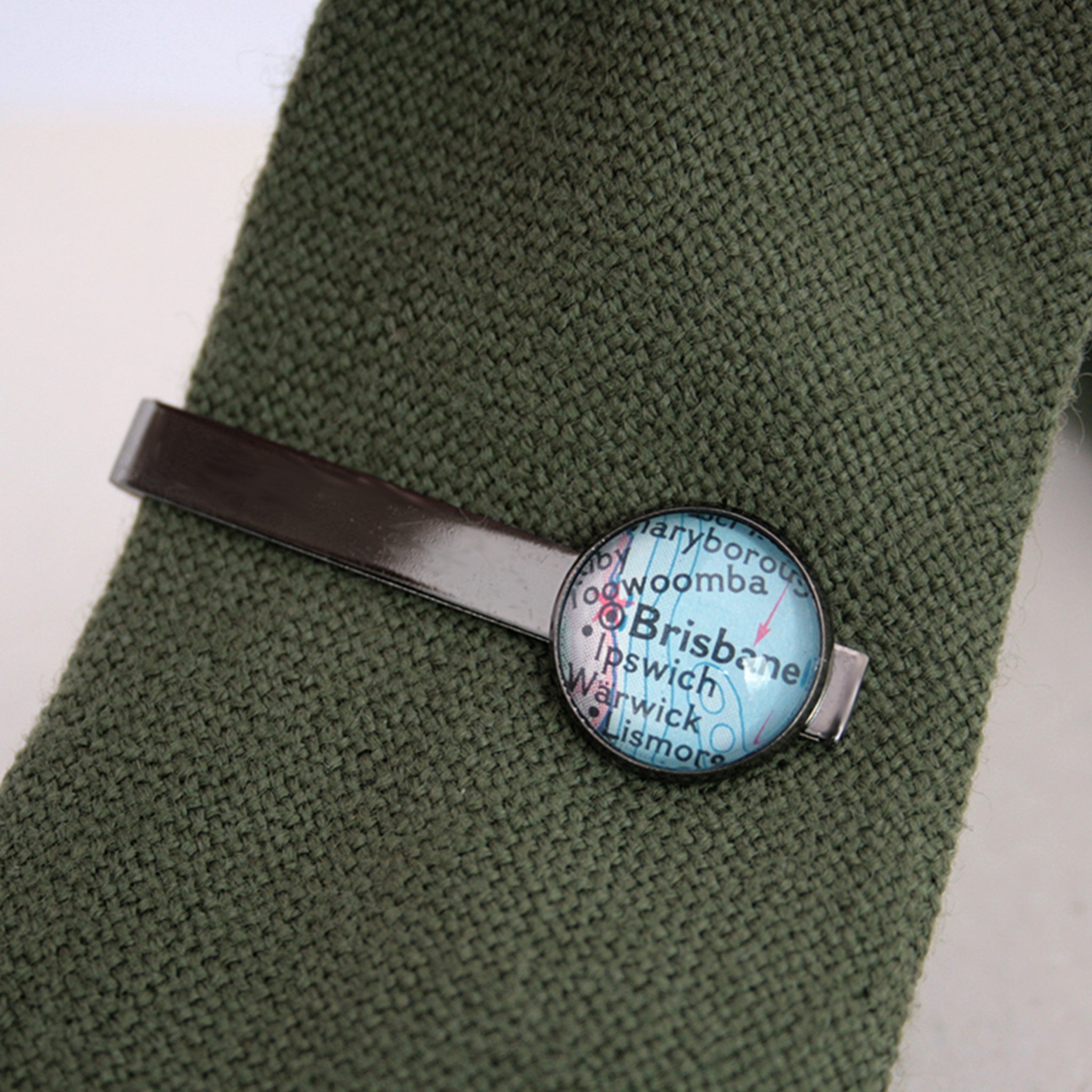 Personalised Tie Clip in gunmetal black color featuring map of Brisbane on a green tie