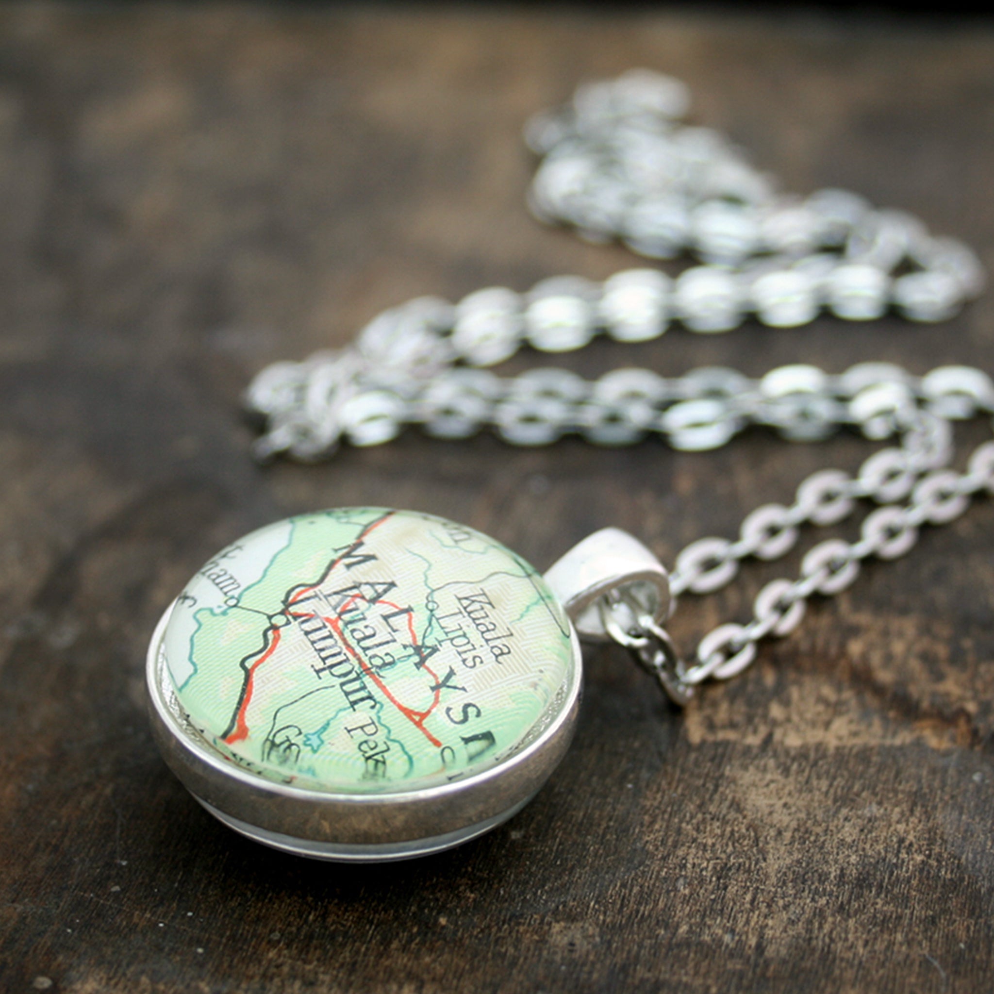 Silver tone double sided pendant necklace featuring map of Malaysia