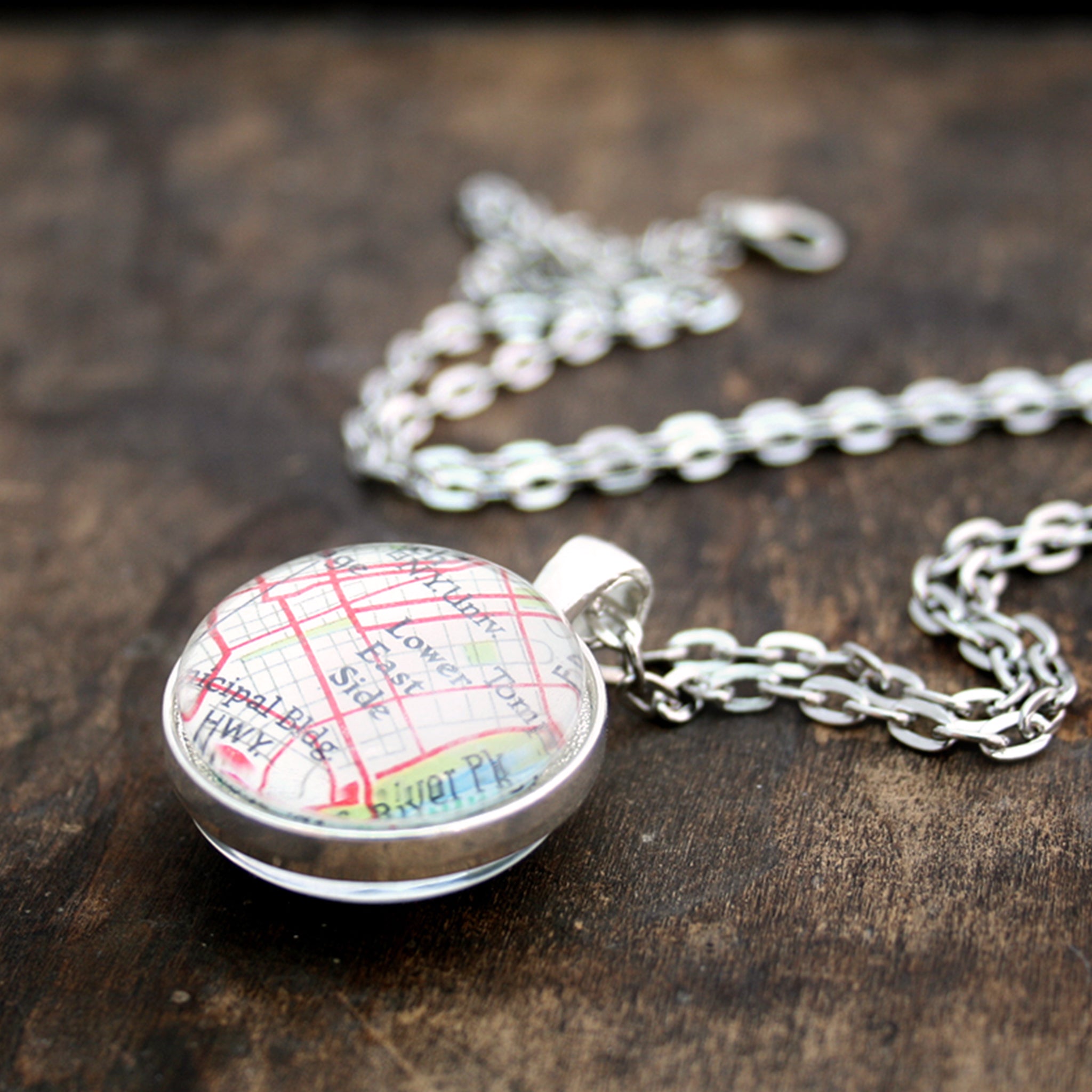 Silver tone double sided pendant necklace featuring map of New York City