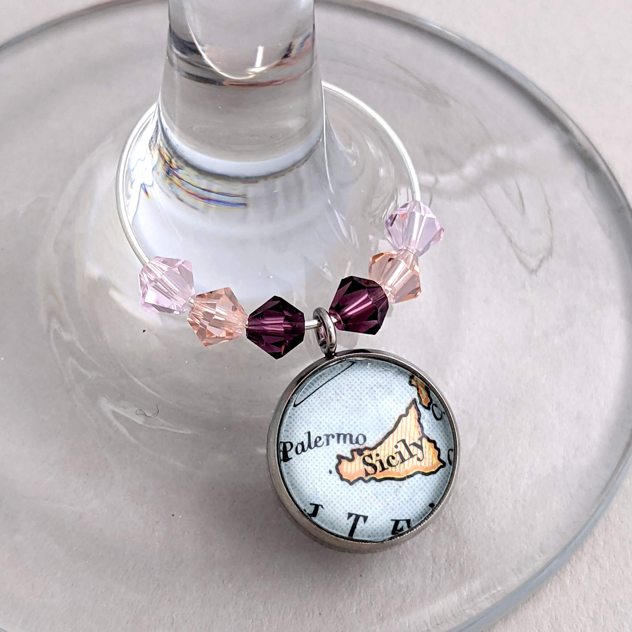 wine glass charm in pink tones personalised with map of Sicily